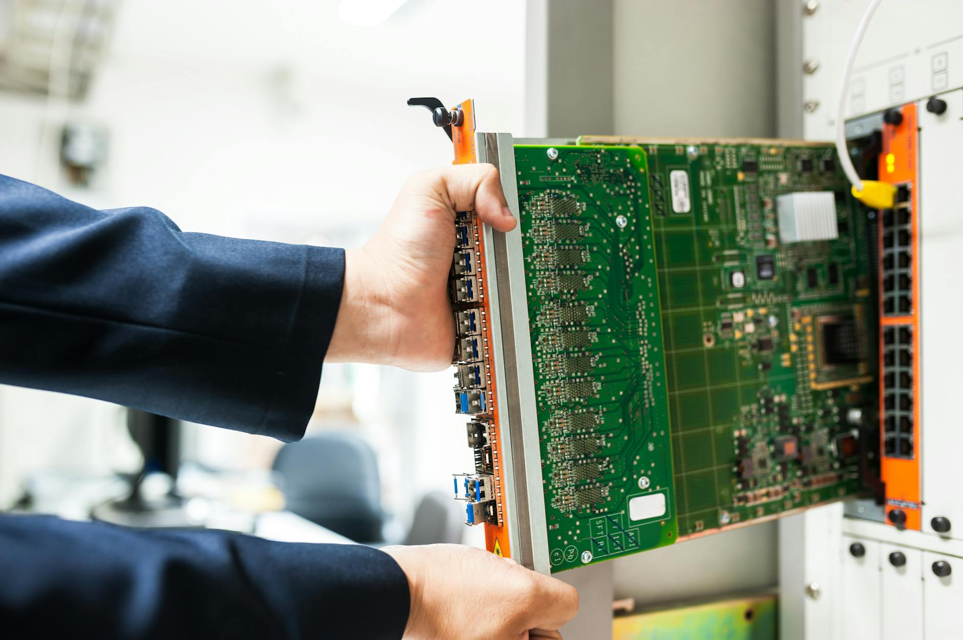 Engineer fixing core switch in data center room