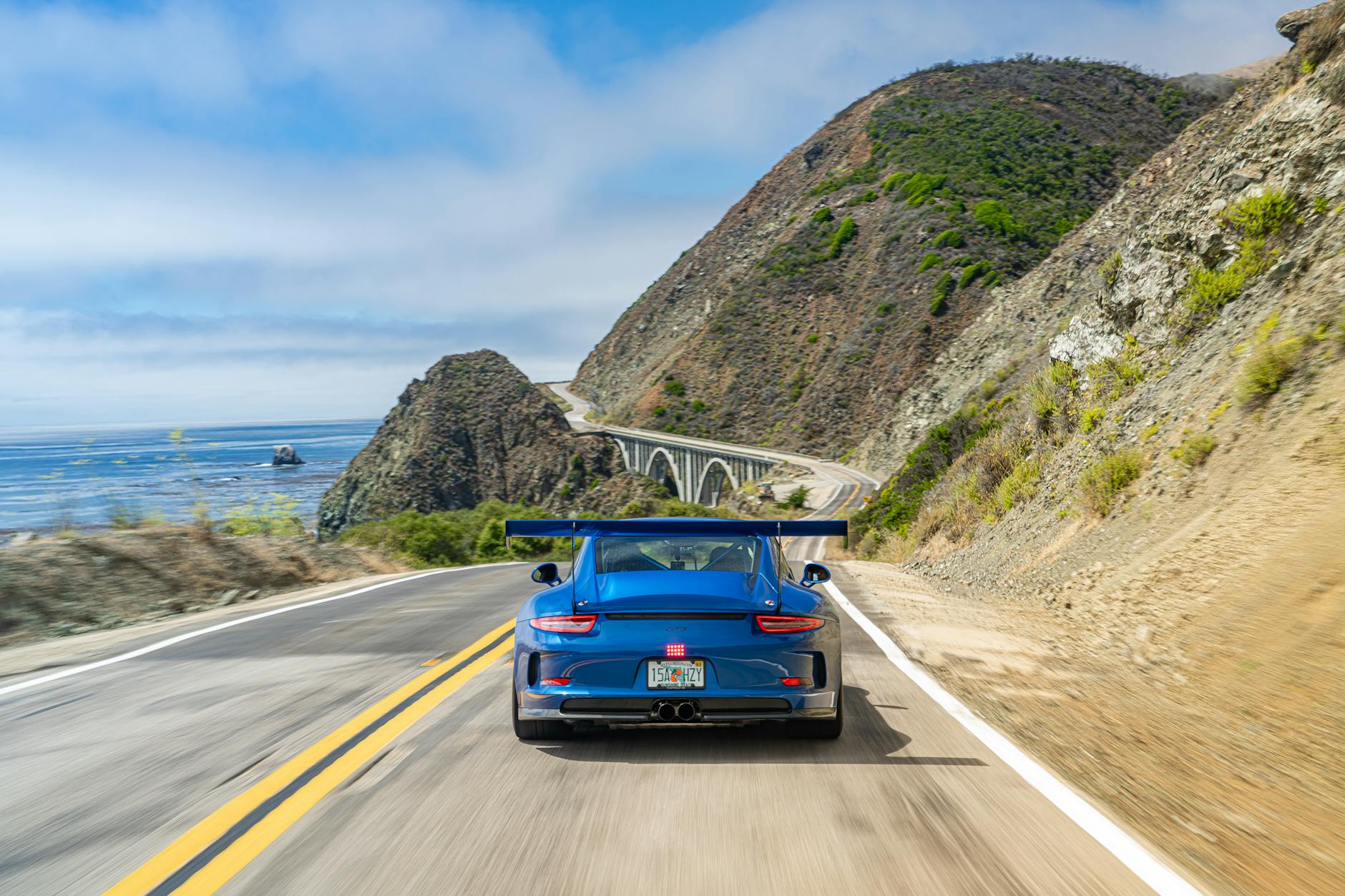 Blue Sports Car on Road on Sea Coast