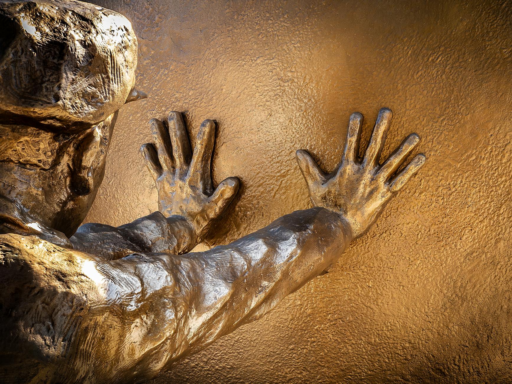 Statue of Man Touching Wall