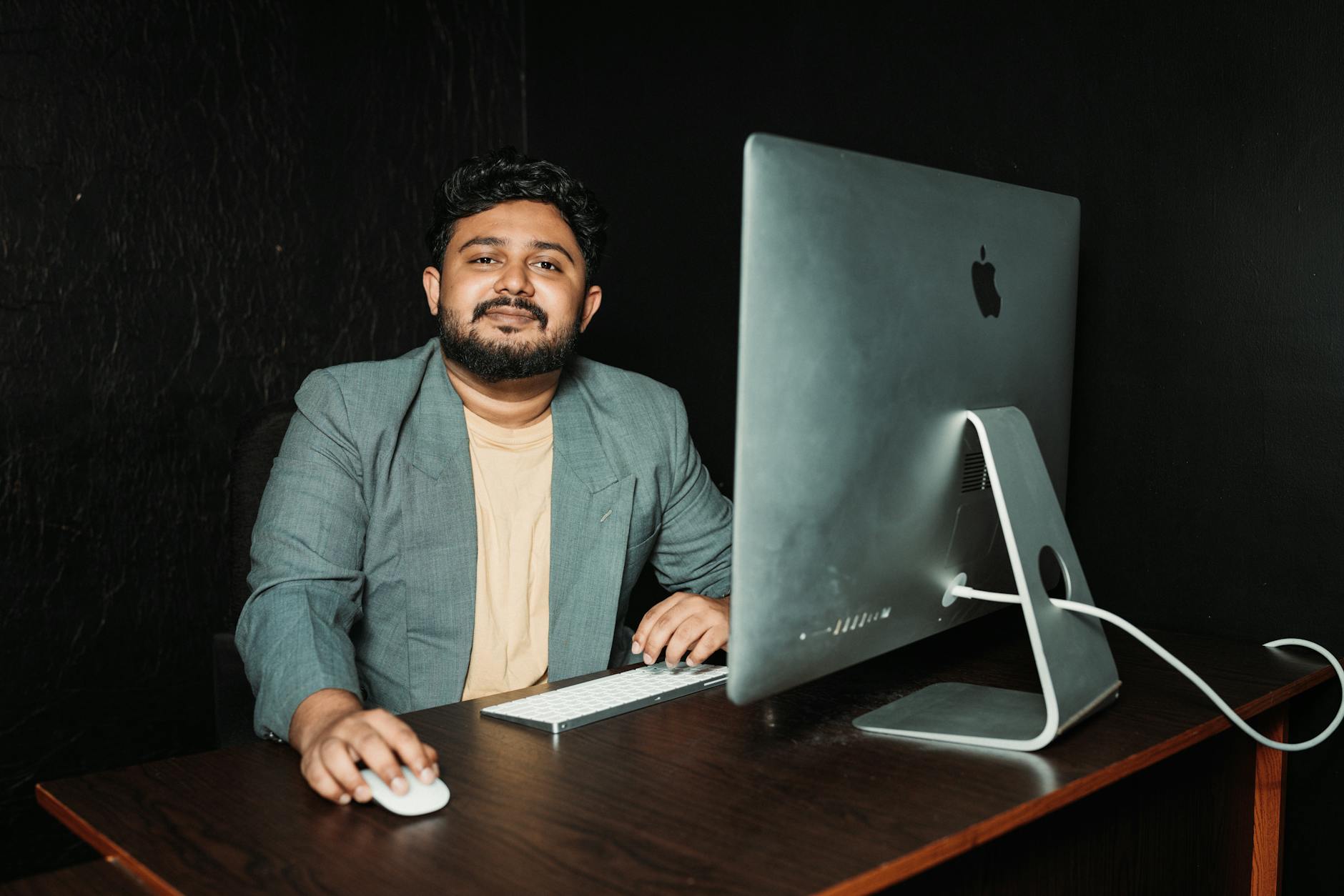 Man at Office Desk with Wireless Keyboard and Mouse