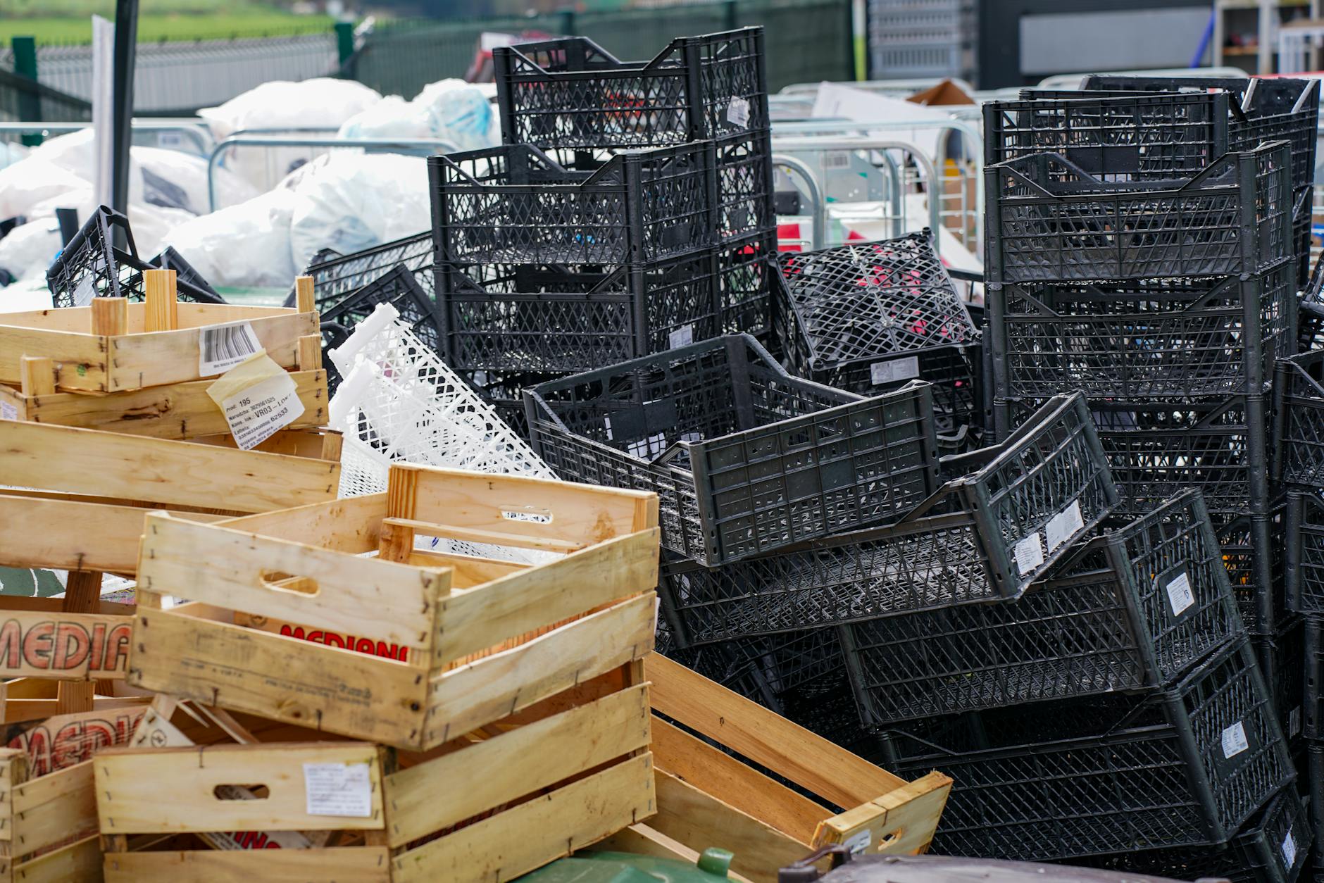 A pile of empty wooden and plastic crates