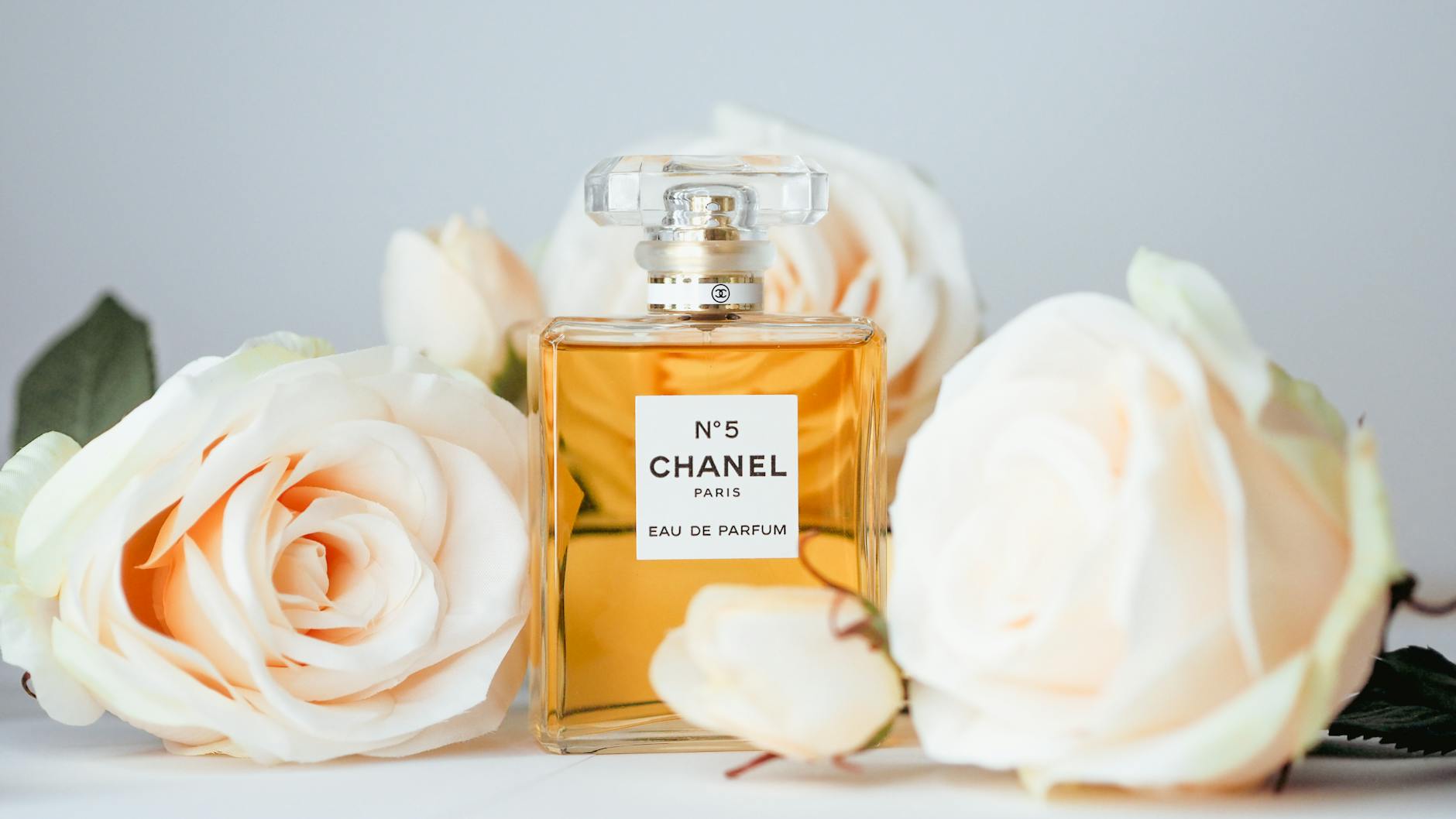 A Bottle of Chanel No 5 Perfume and Flowers