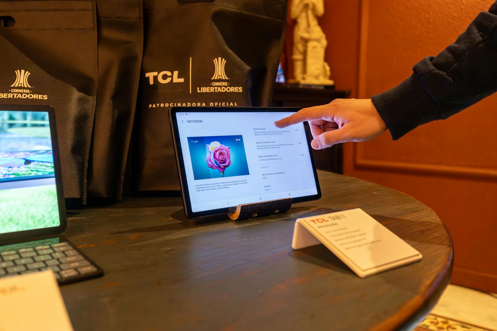 A Man Touching a Tablet Standing on Display in a Store with Electronics