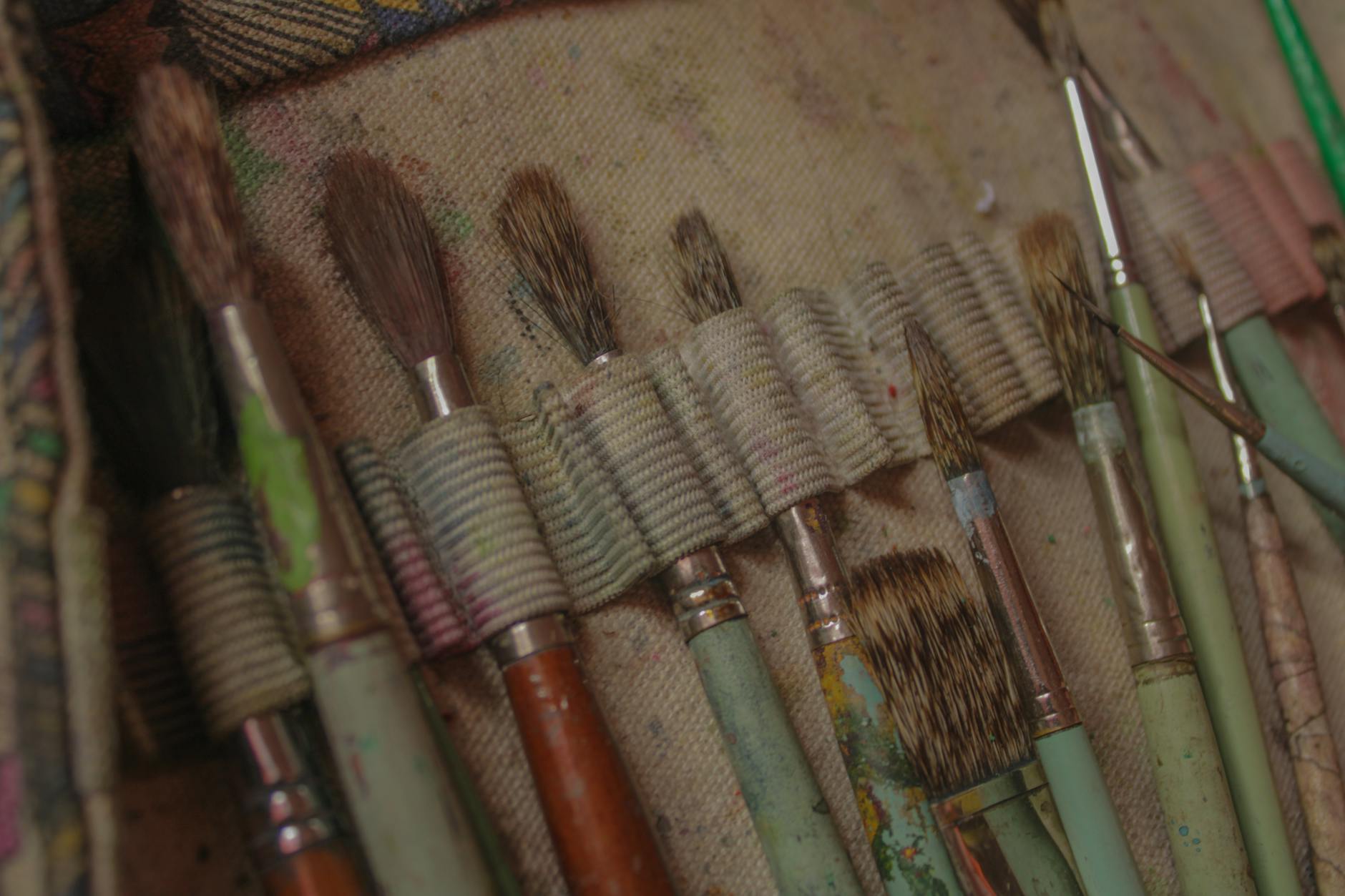 A close up of a bunch of brushes and paint