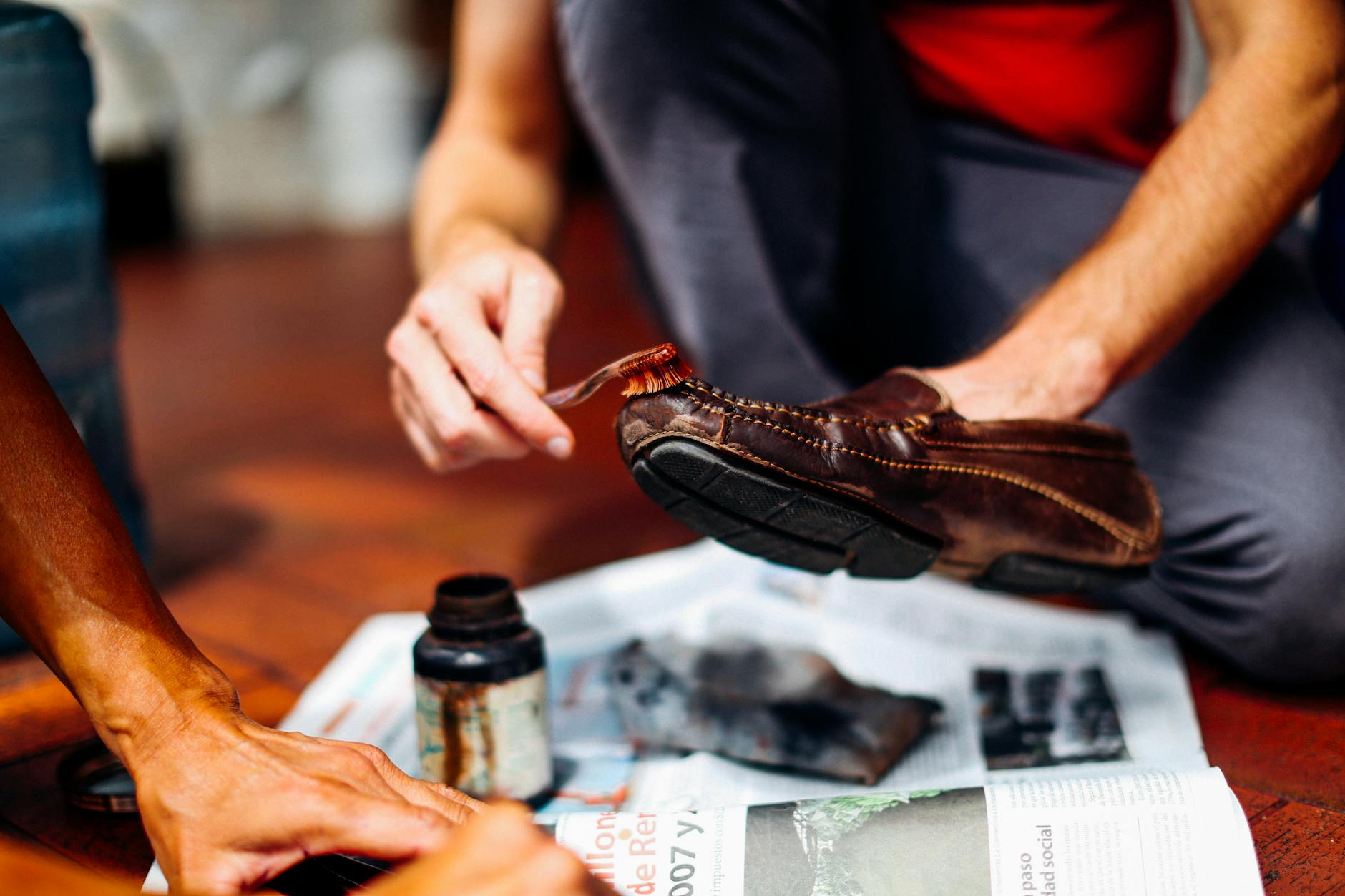 Person Brushing Brown Dress Shoe