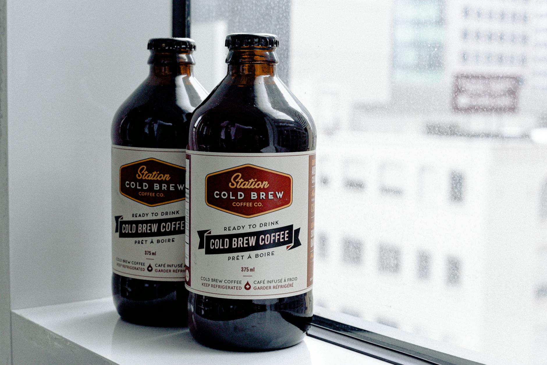 Close-up Photo of Station Cold Brew Coffee Bottles by Window