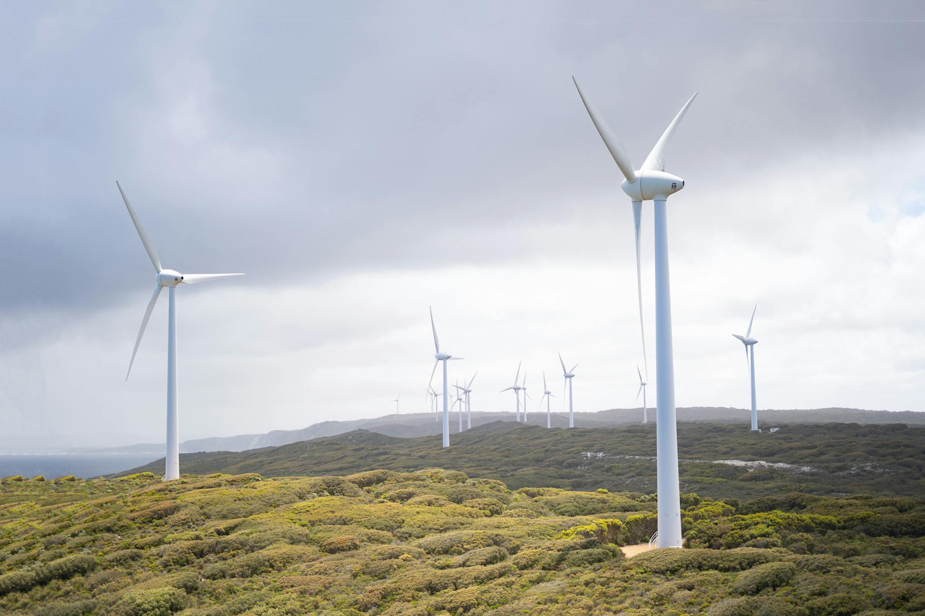 Wind Turbines Under Cloudy Sky