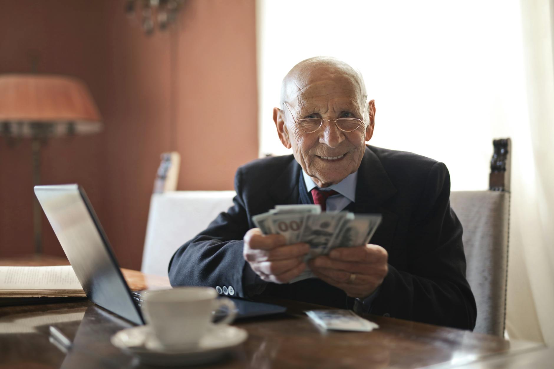 A confident senior couple looking at graphs on a laptop