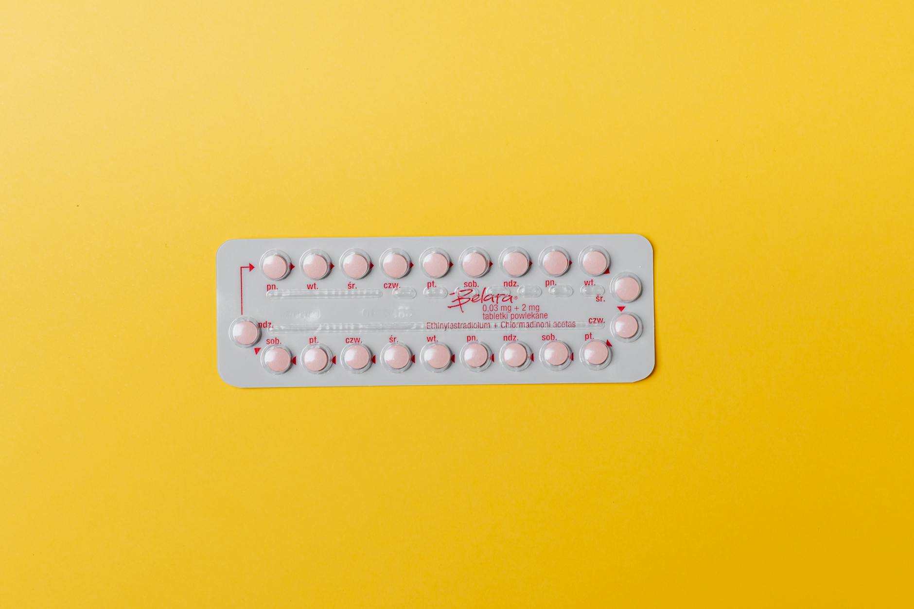 Pink Pills on Yellow Surface