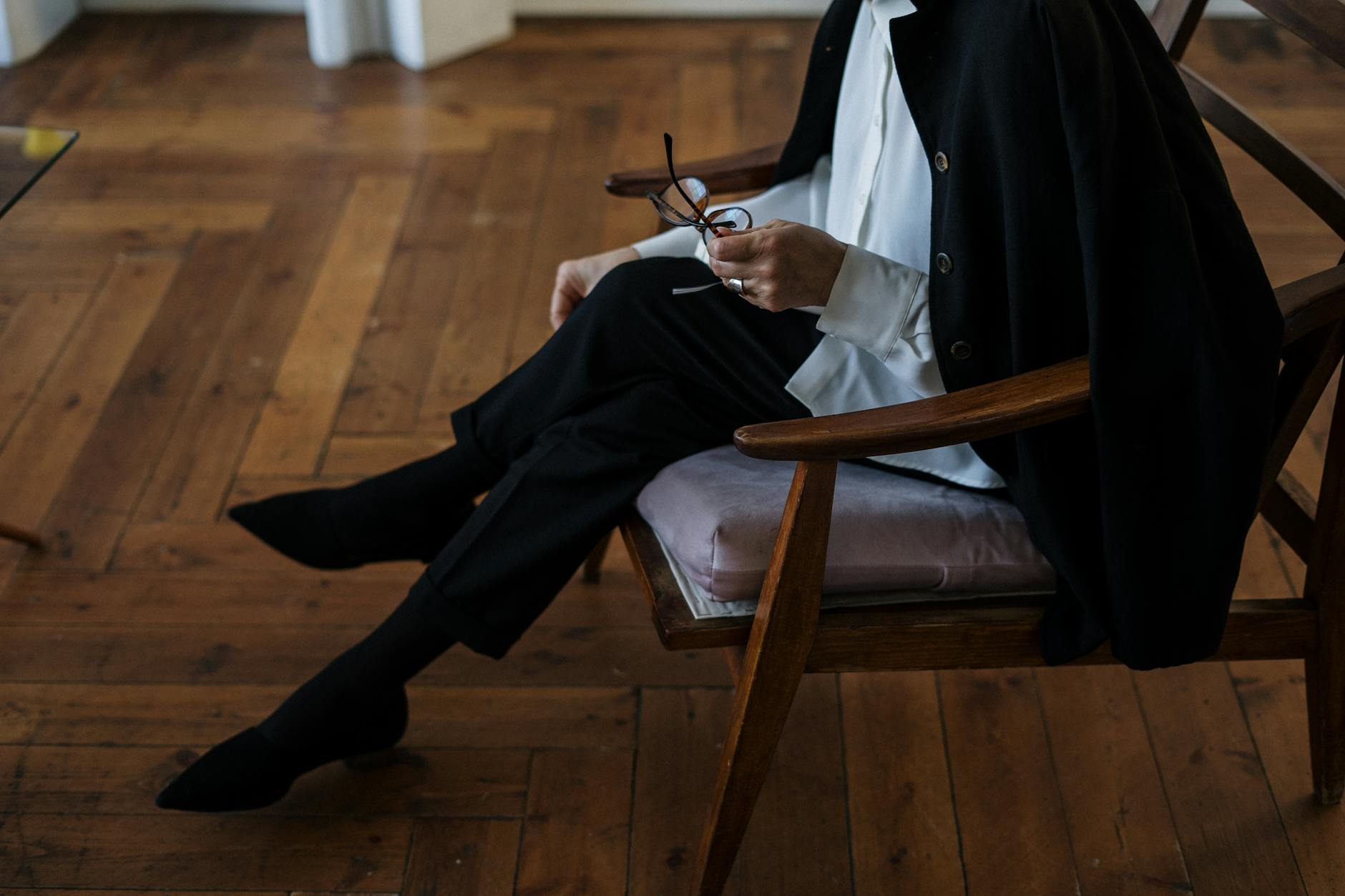 Man in Black Suit Sitting on Brown Wooden Chair