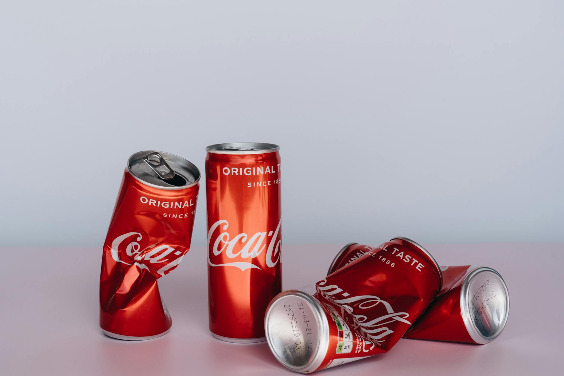 A variety of canned beverages, representing different brands, sitting on a table