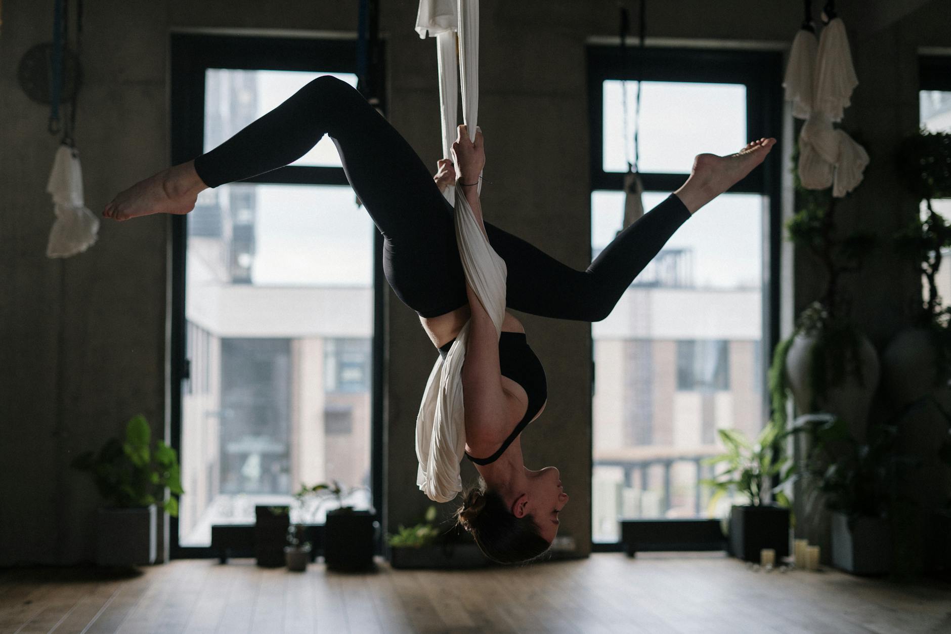 Woman in White Tank Top and Black Pants Doing Yoga