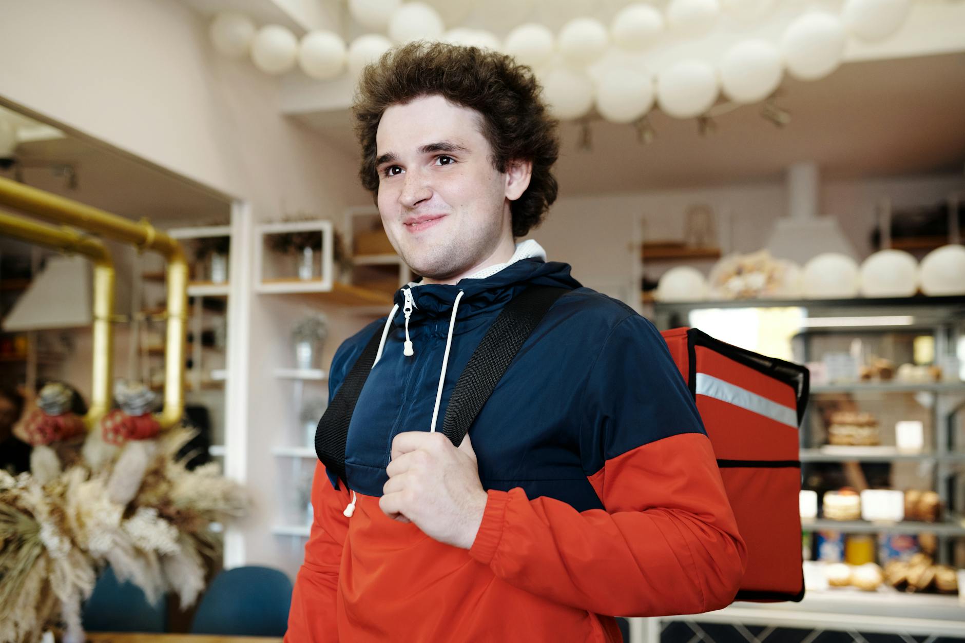 Smiling man carrying groceries