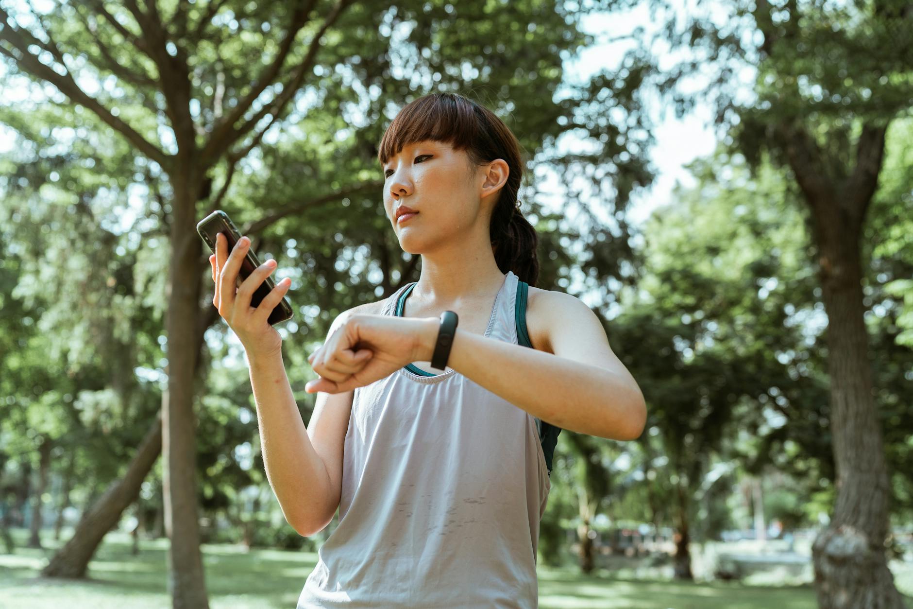 Athlete using smartphone and fitness tracker