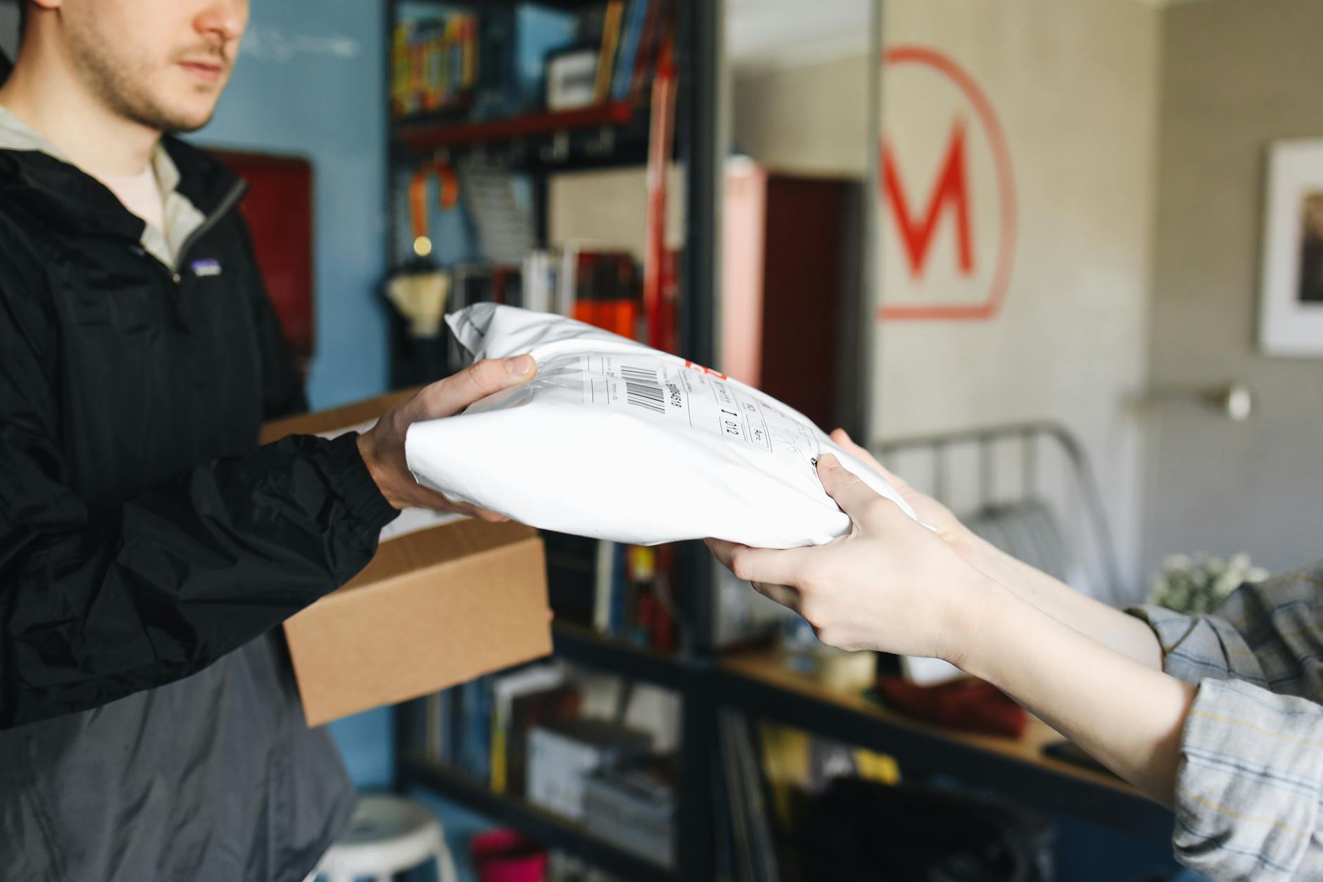 A Man Receiving Parcels for Delivery