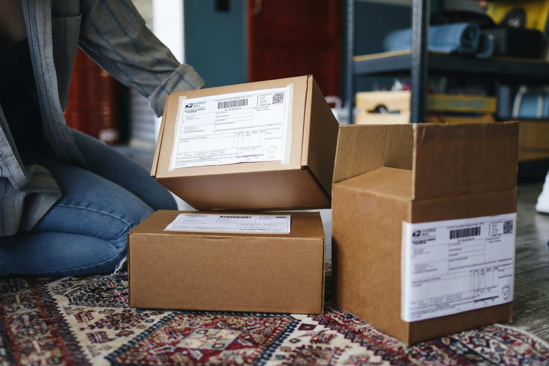 Woman Kneeling Next to Delivered Parcels