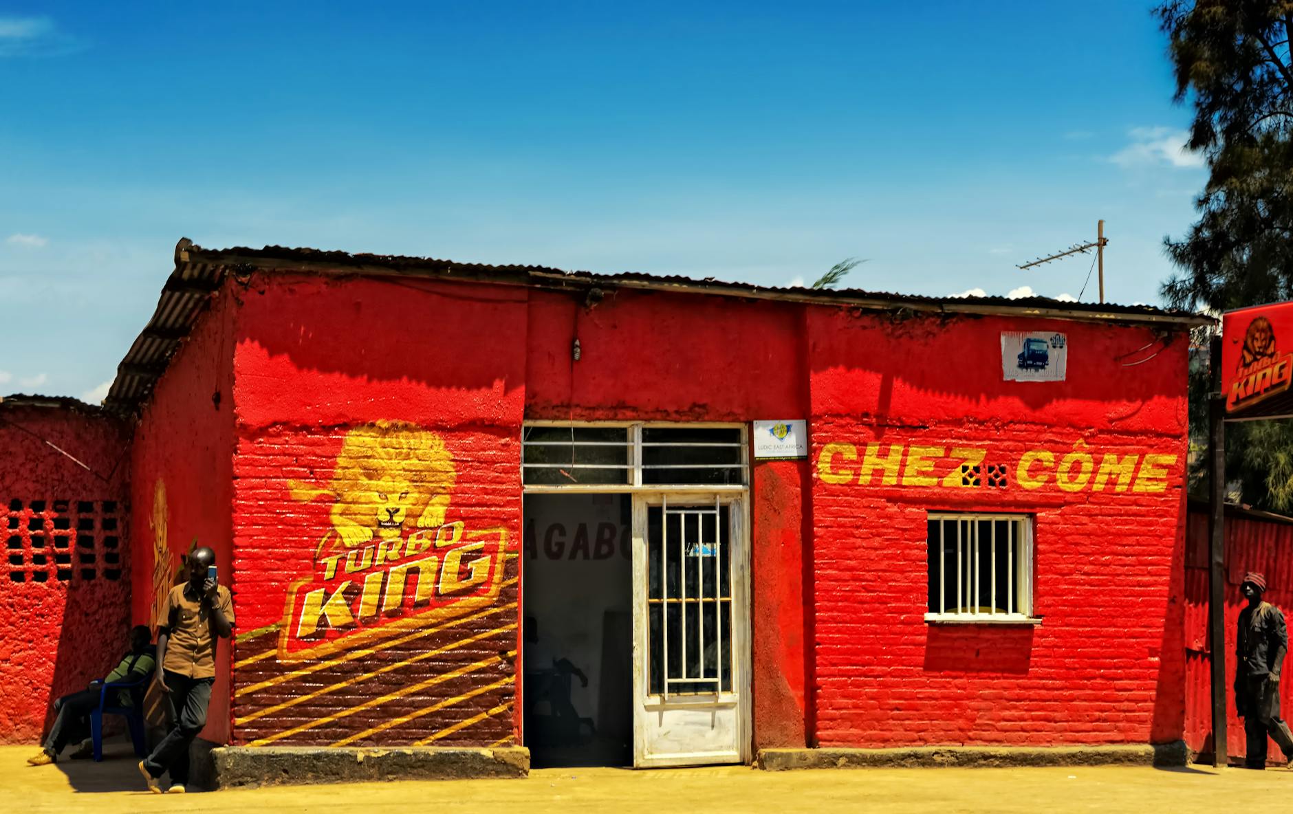 Red and White Concrete Building Under Blue Sky