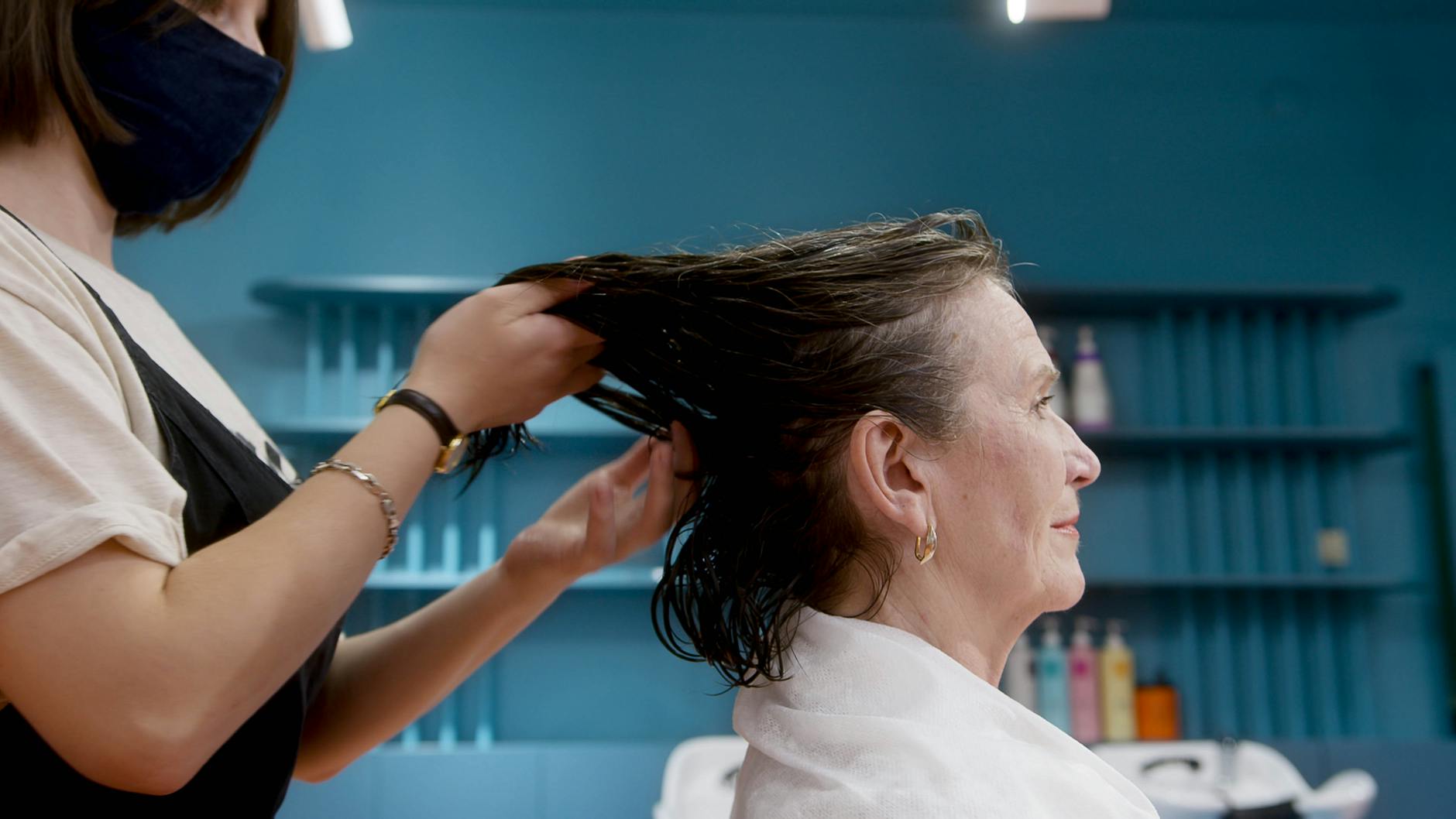 Hairdresser Touching a Client's Wet Hair