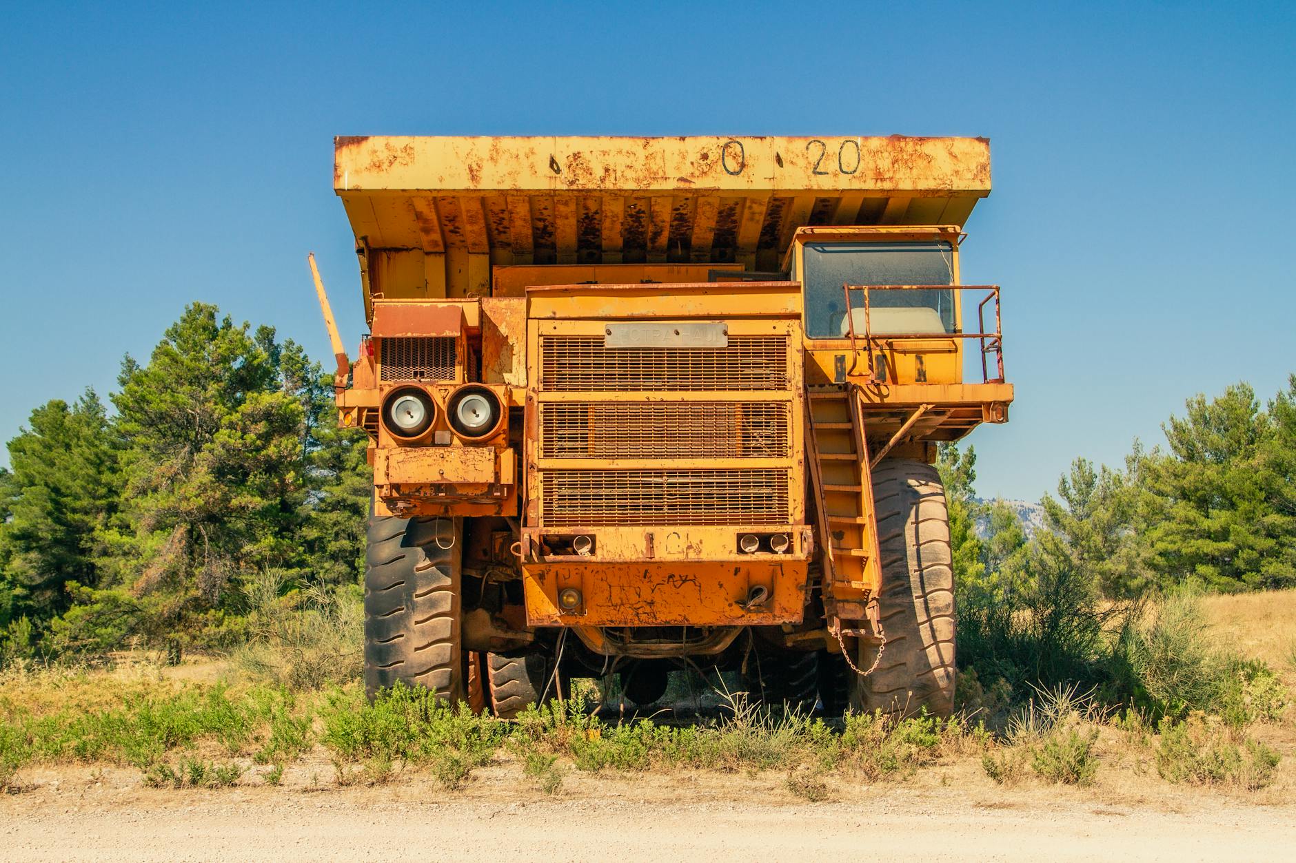 Rusty tipper truck on field in countryside