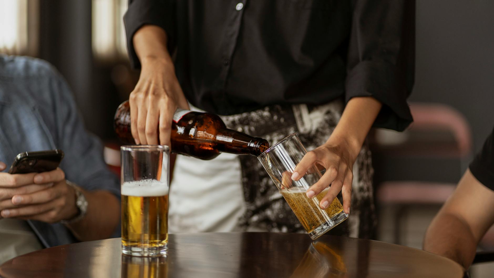 Waitress Filling Up the Glass with Beer