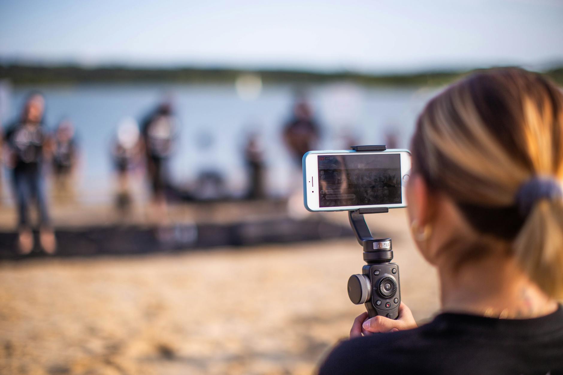 Anonymous woman shooting performance on beach