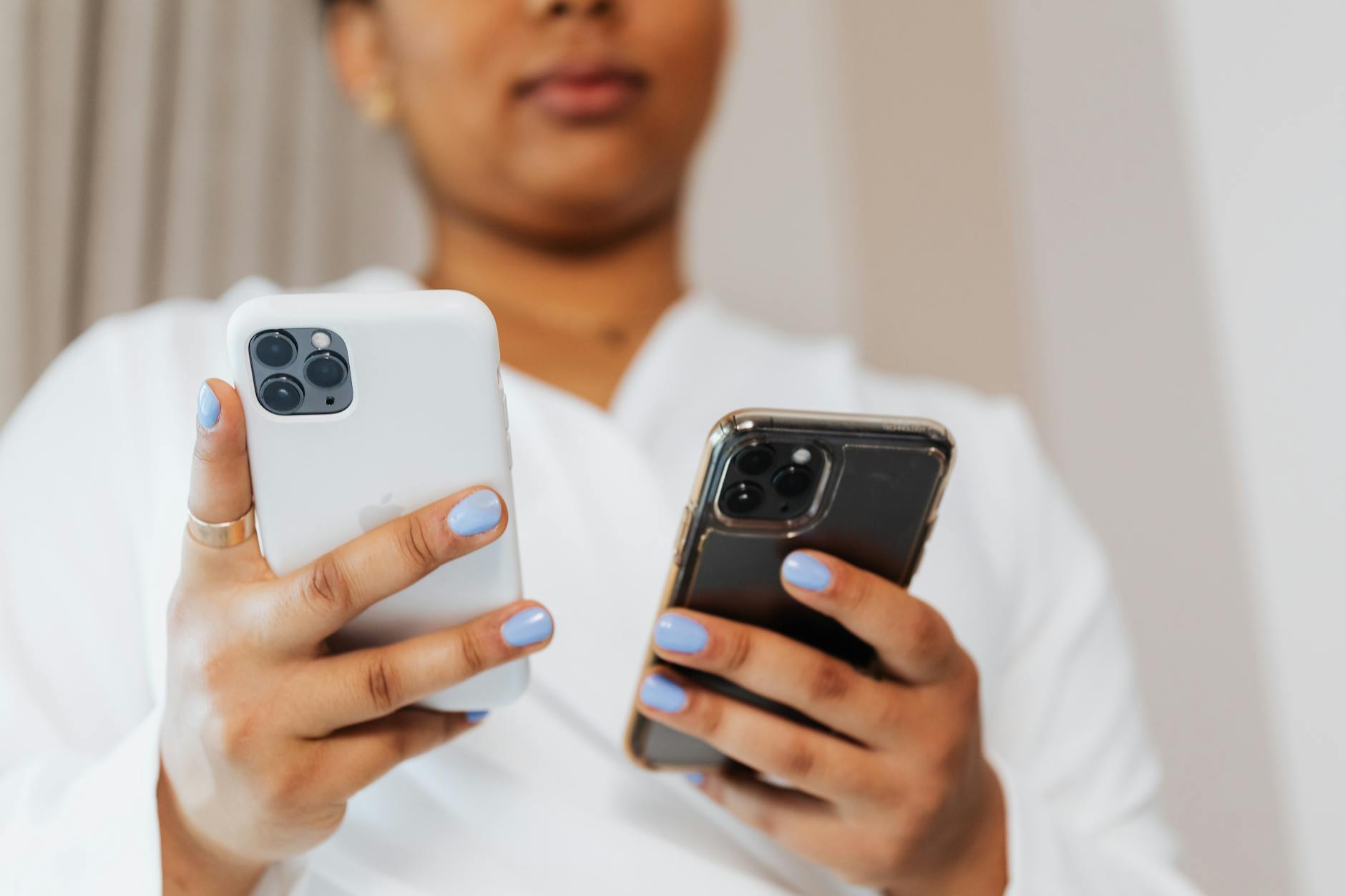 Person holding two cellphones