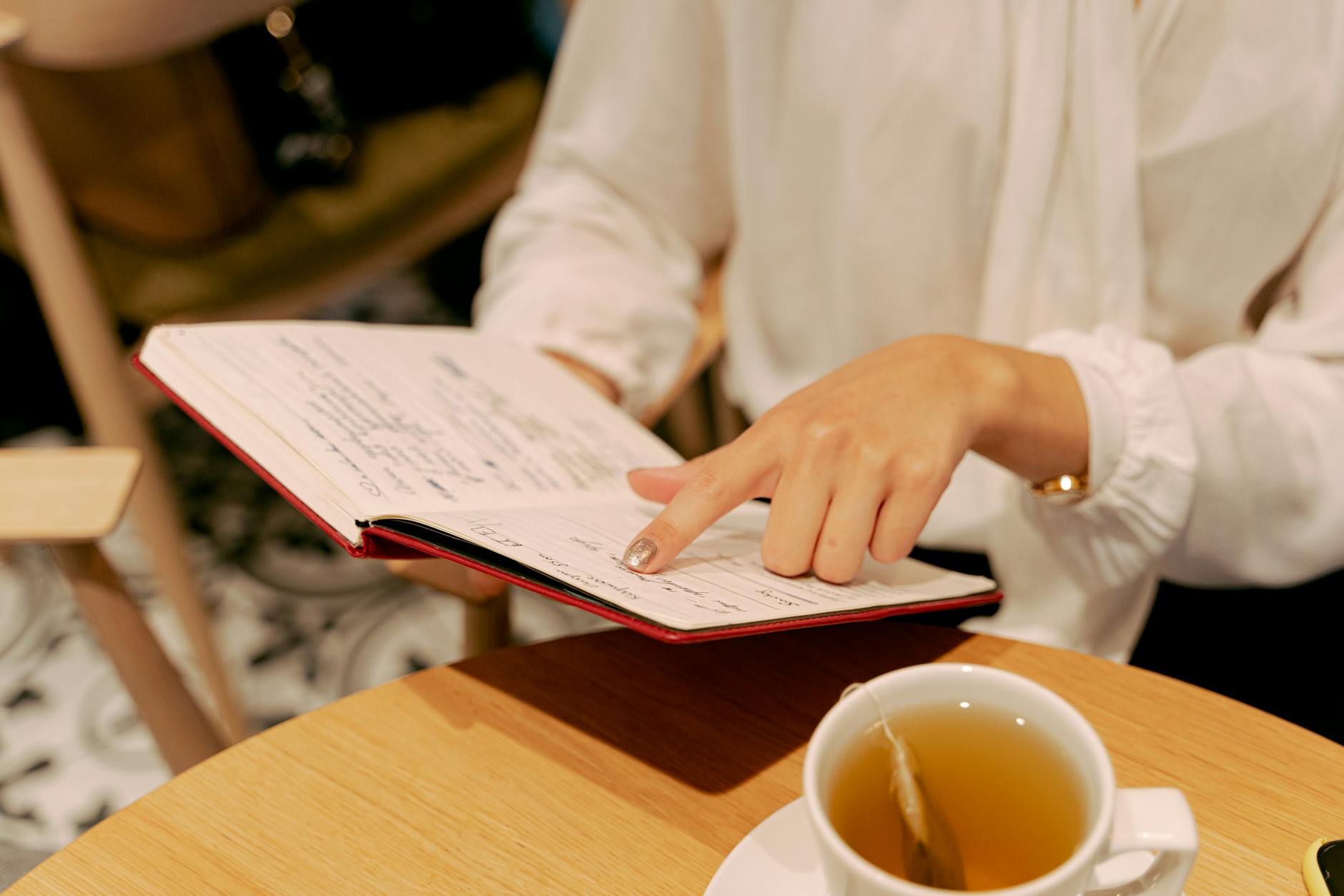 A person smiling and holding a cup of bubble tea