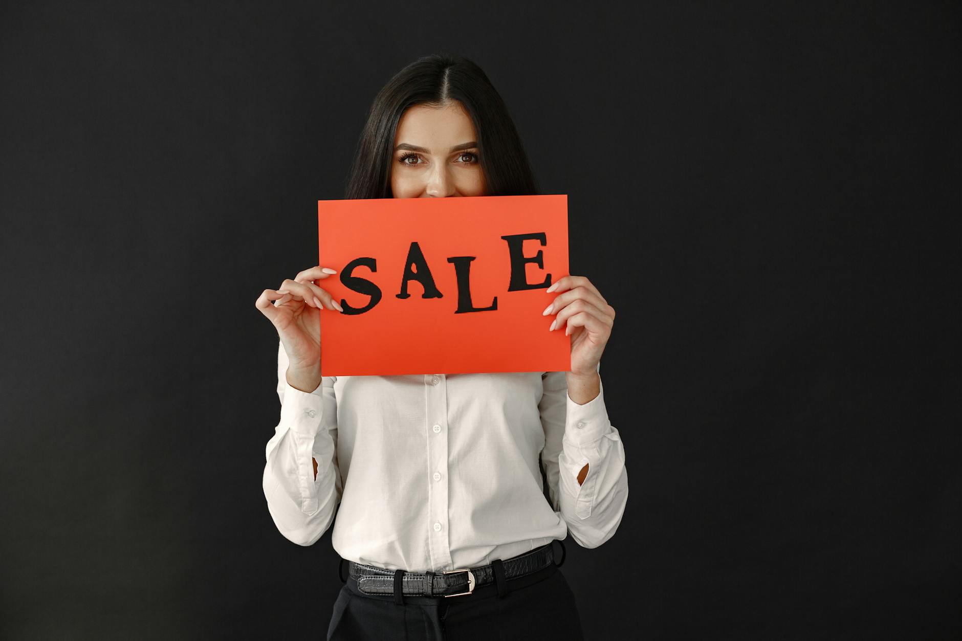 Woman Holding Sale Text on Paper