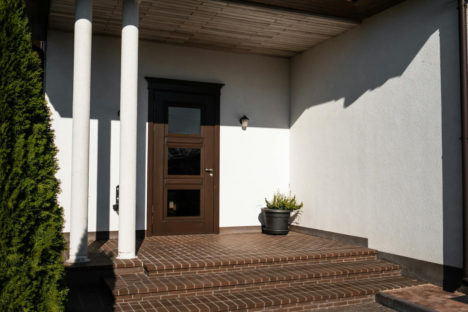 Brown Wooden Door on White Concrete Wall