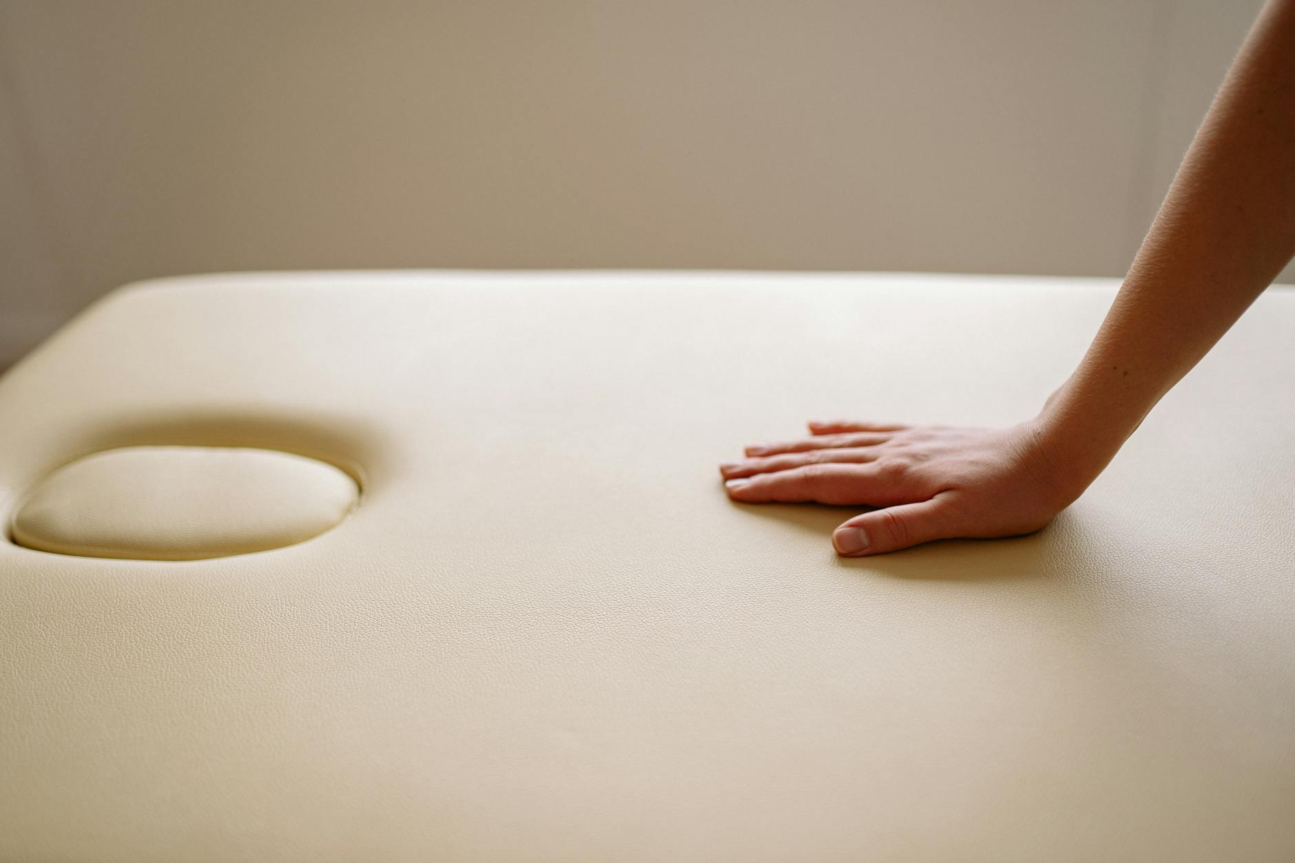 A Person's Hand on a Brown Leather Surface