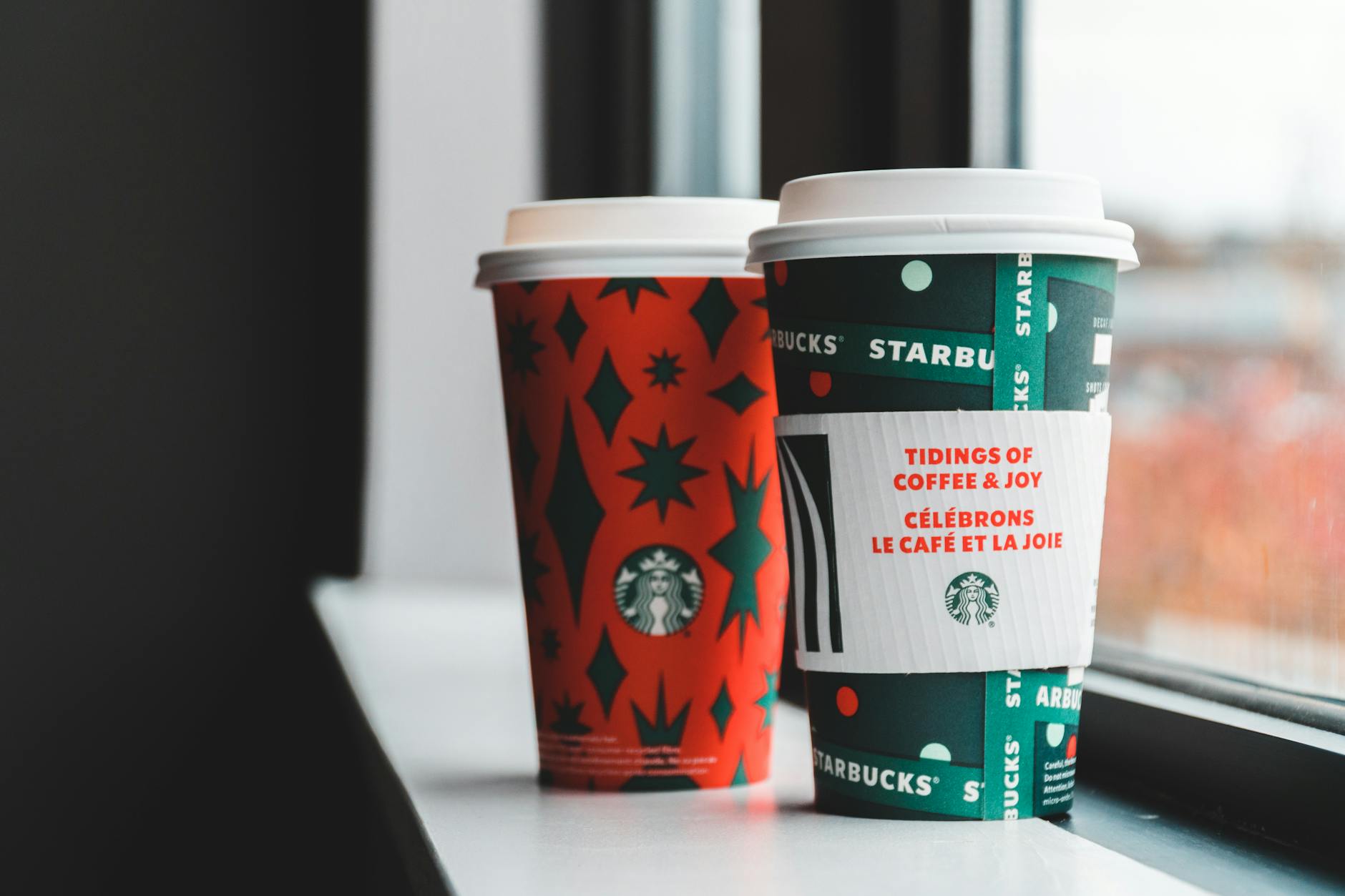 Cups for takeaway coffee on windowsill