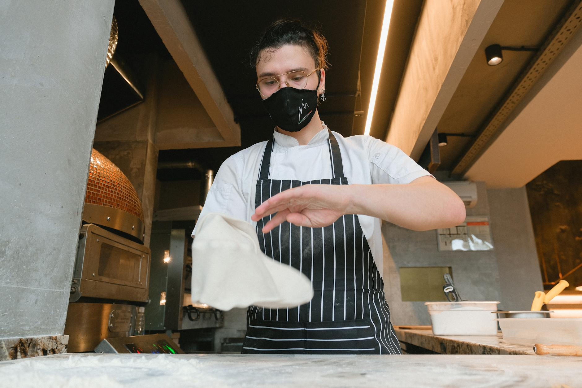 Cook Preparing Dough for Pizza