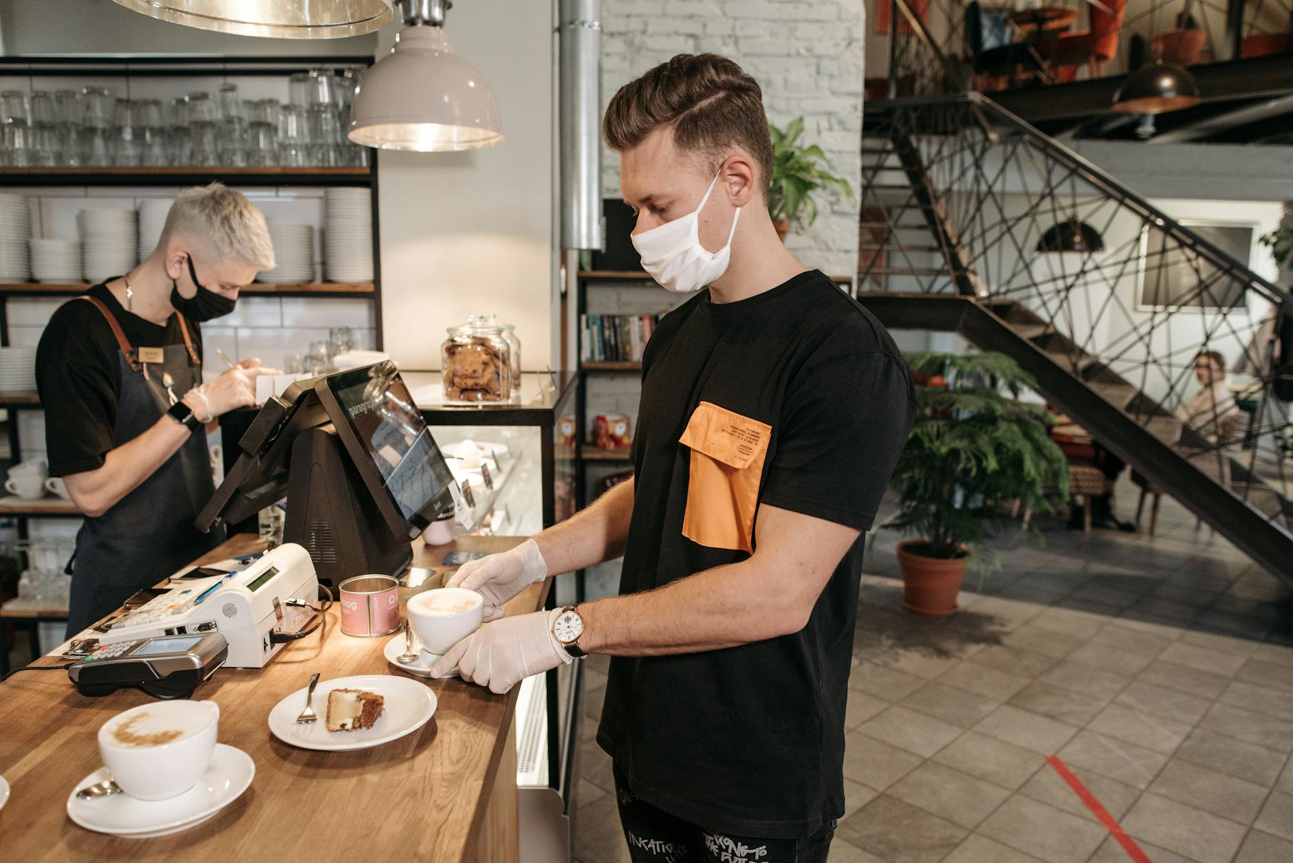 Man in Black Crew Neck T-shirt Holding White Ceramic Plate