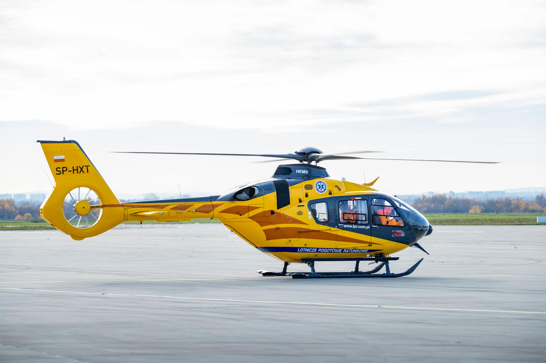 Yellow and Black Helicopter on Concrete Pavement