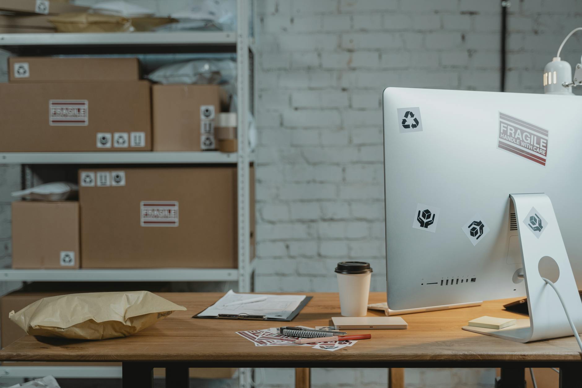 Computer and Parcel on Wooden Table Top