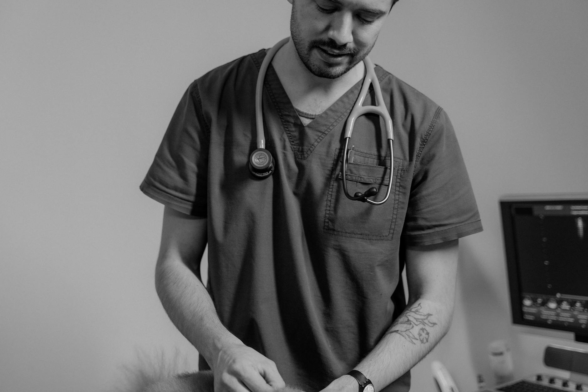 A Man in Scrub Suit with a Stethoscope Wrapped on His Neck