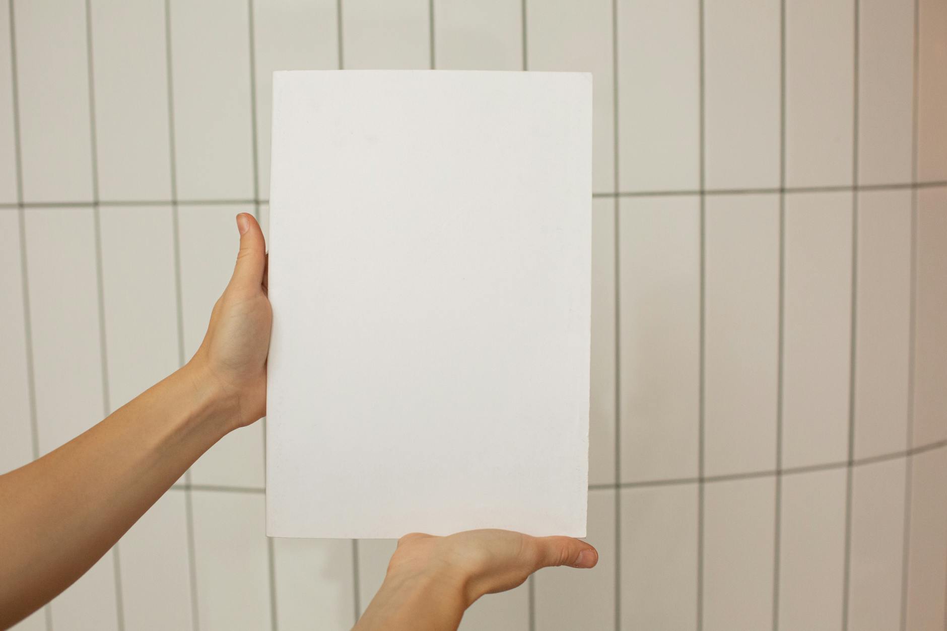 person showing empty sheet of paper