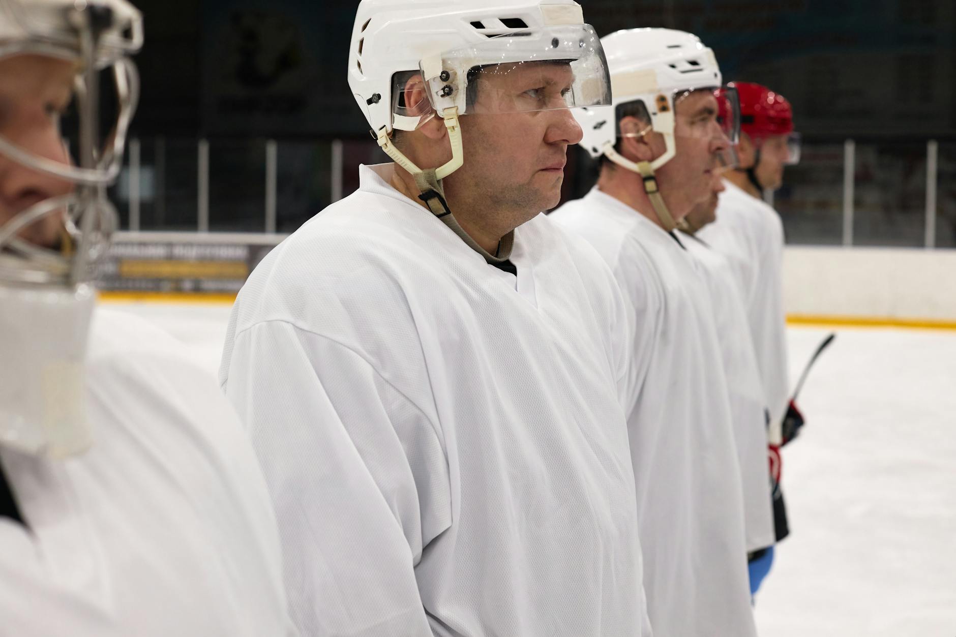 A Group of Men in White Ice Hockey Uniform Forming a Line