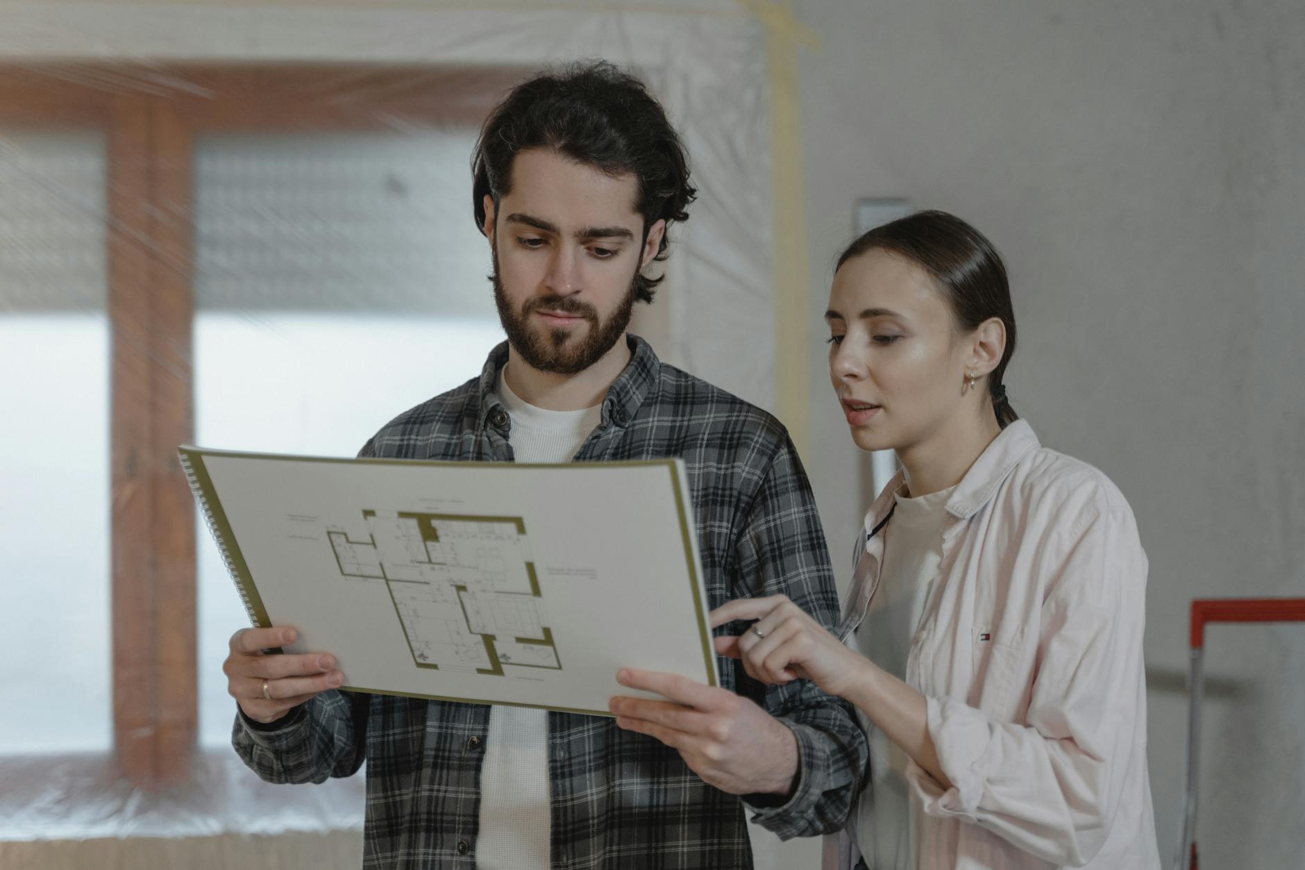 Couple Discussing About Floor Plans