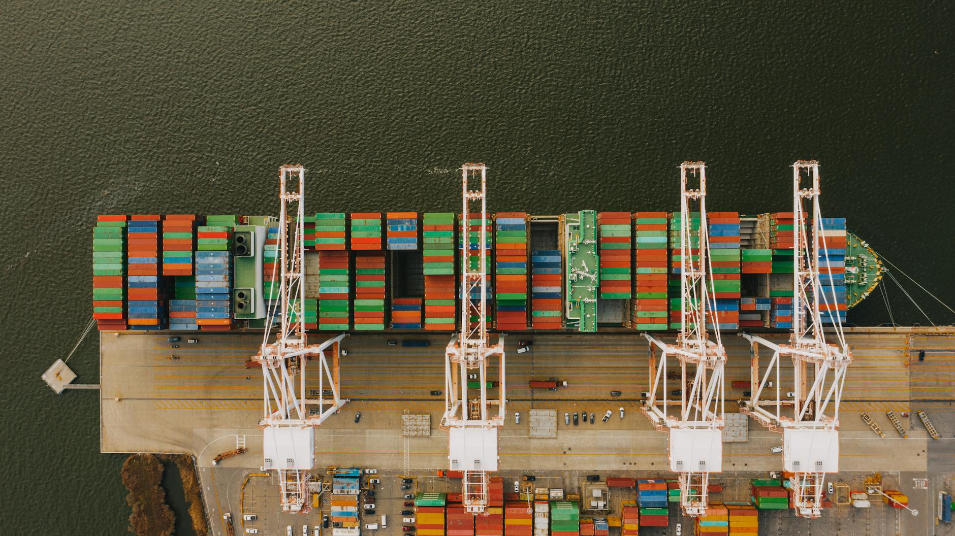 Colorful cargo containers on ship near pier