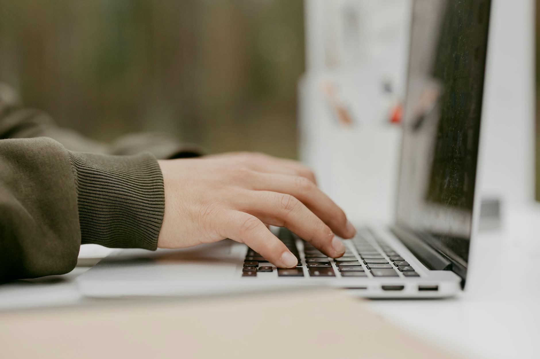 Hands Typing on a Laptop