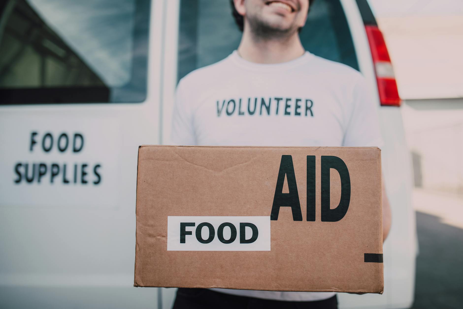 Male Volunteer Carrying a Box