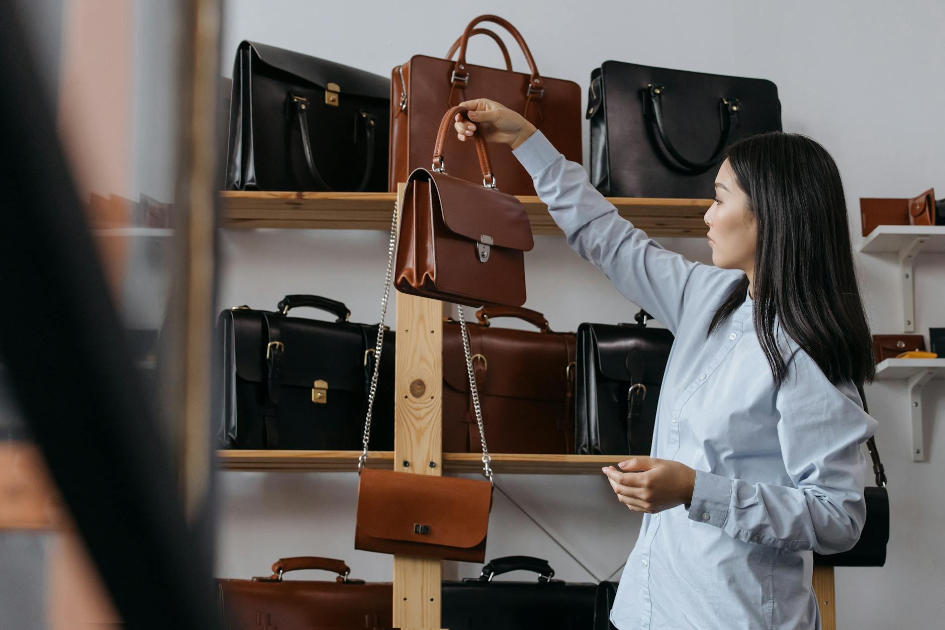 Woman Holding a Brown Leather Handbag