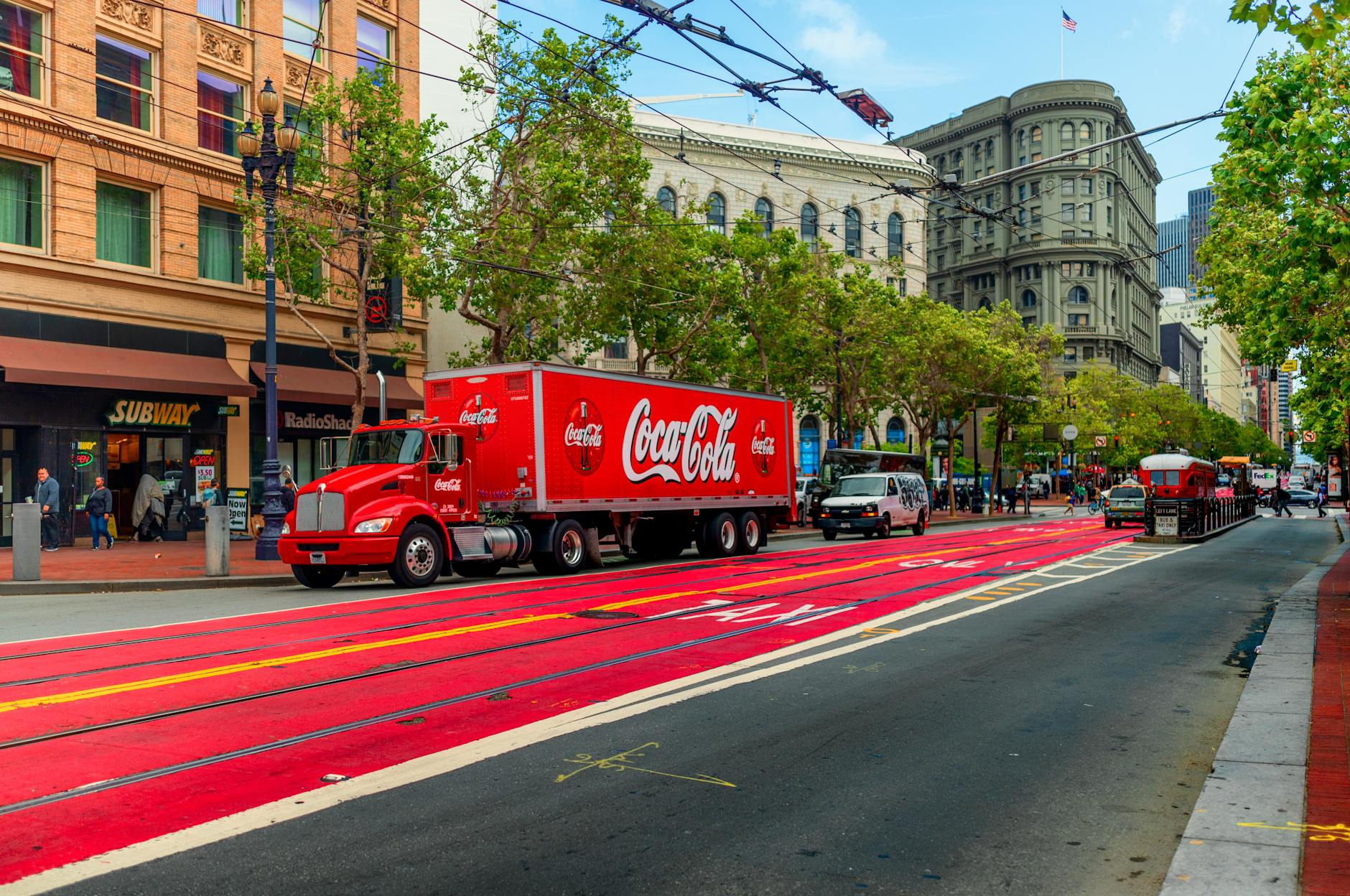 A Red Truck on a Road in a City