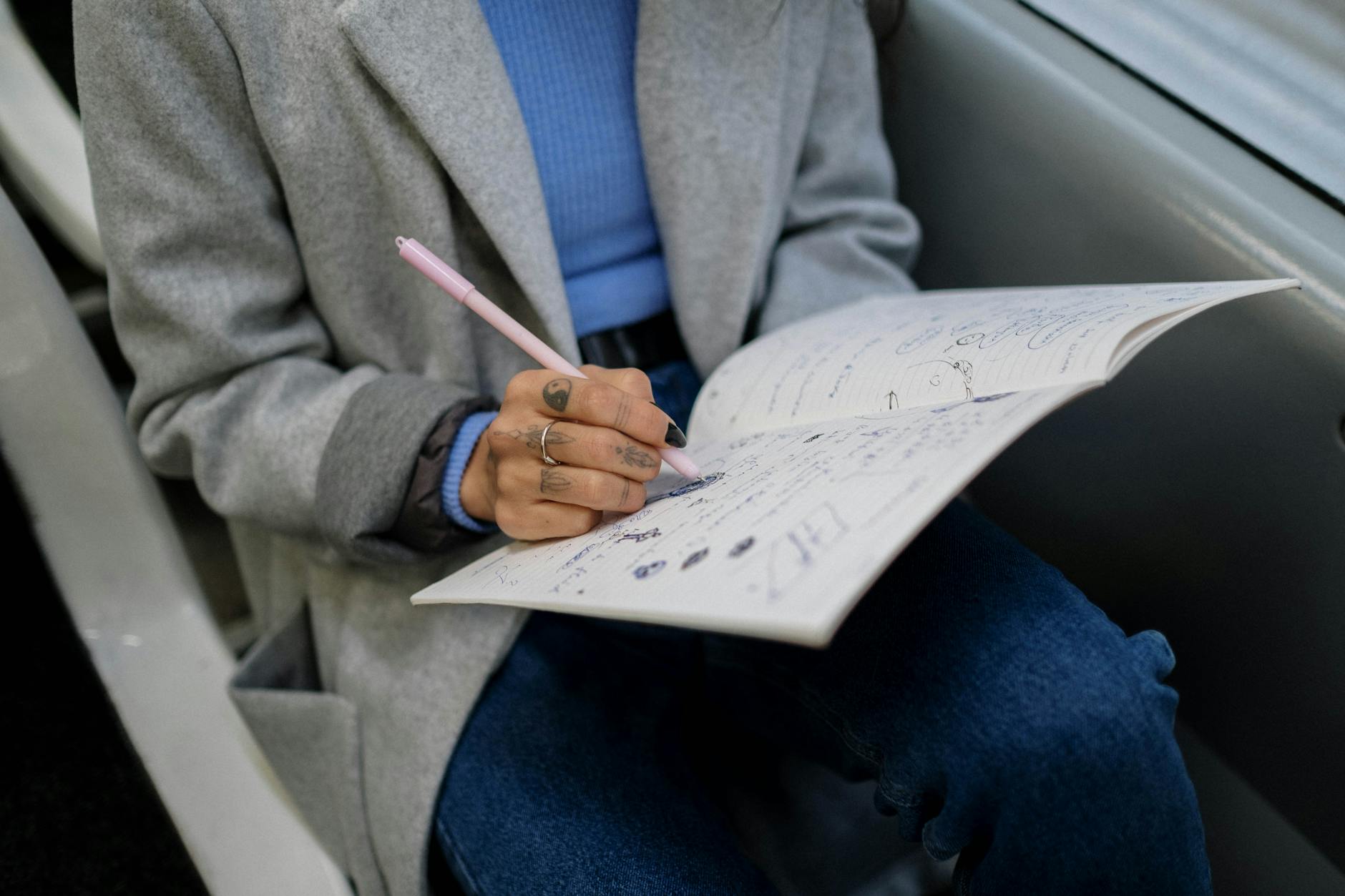 A Woman Writing Inside a Bus