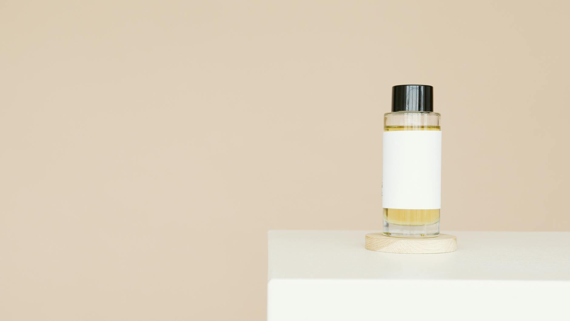 White and Gold Bottle on White Table