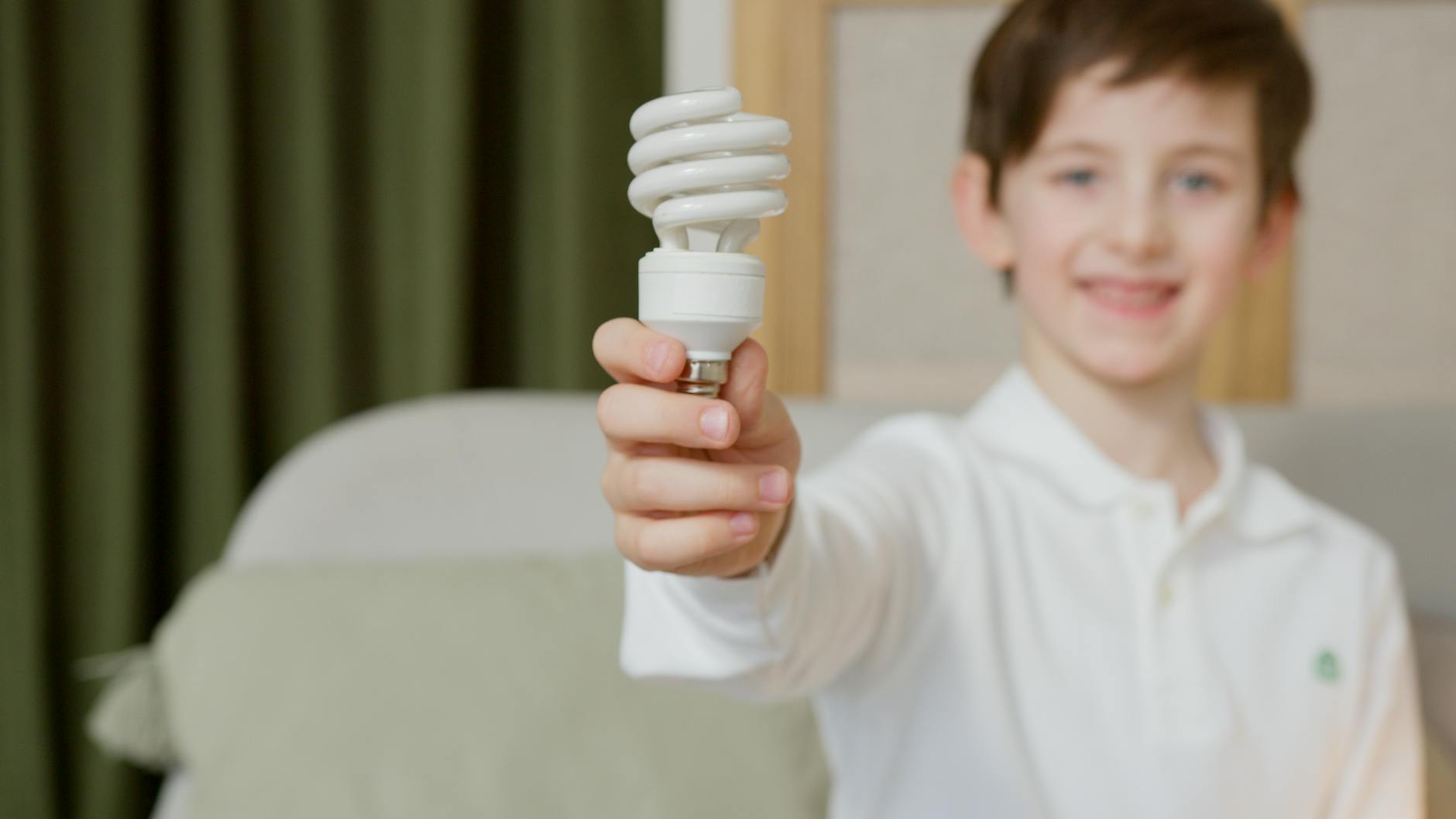 Boy holding a light bulb