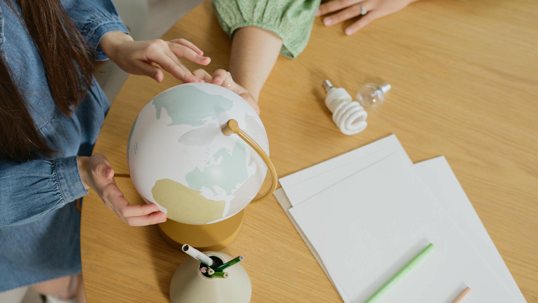 People Holding a Globe