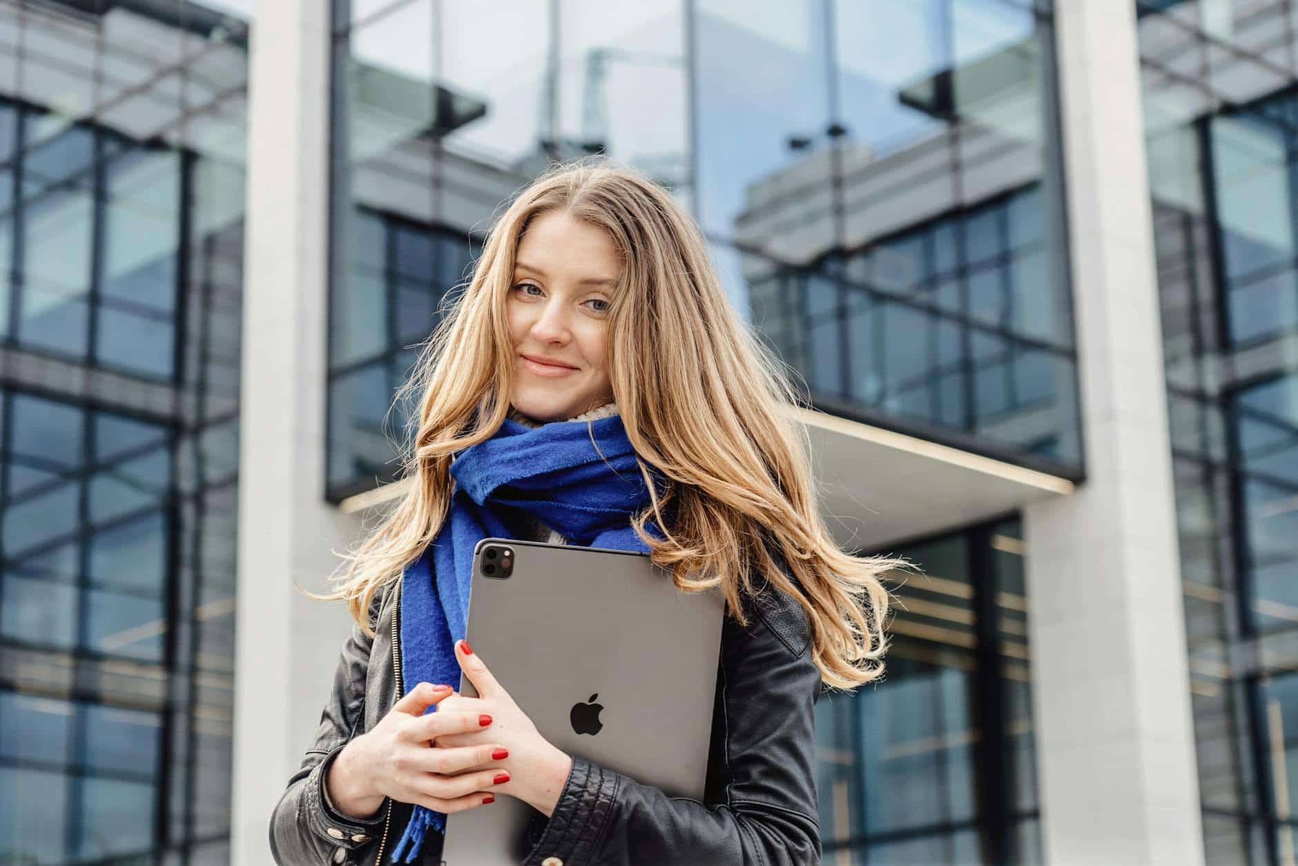 Smiling Woman carrying an Ipad