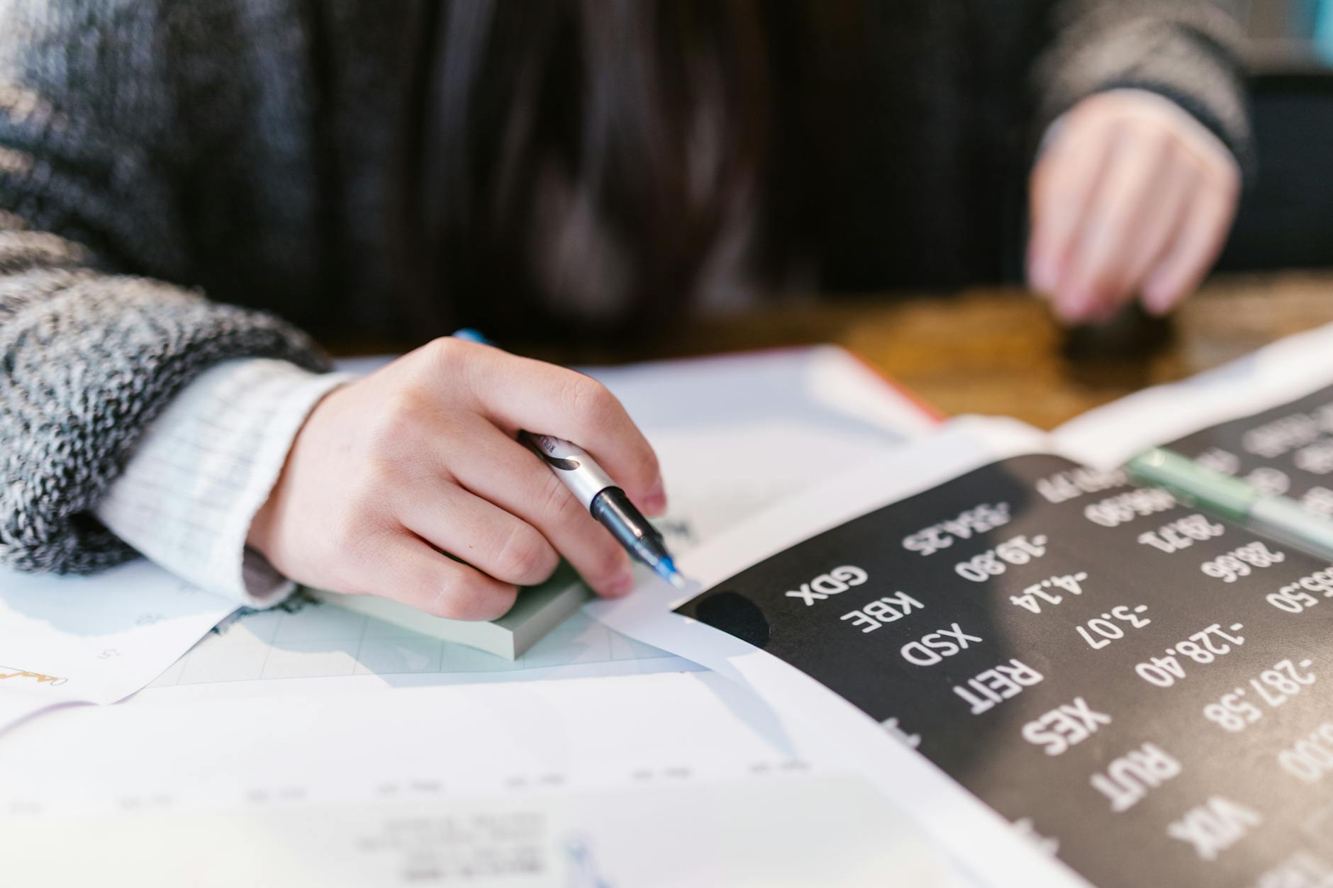 Person Writing on White Paper